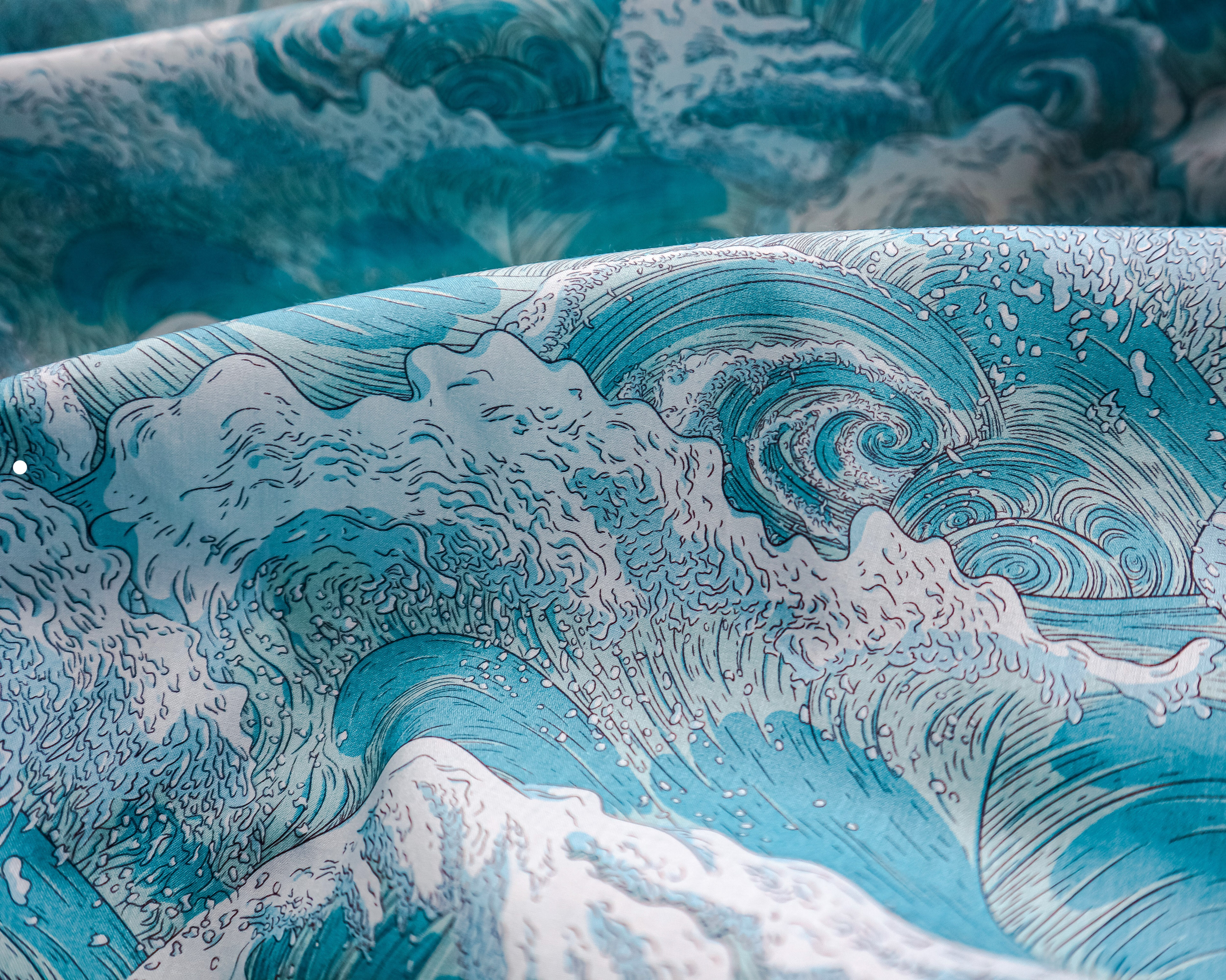 Photograph of an intricate wave design illustrated by Sam Wilde printed onto fabric.