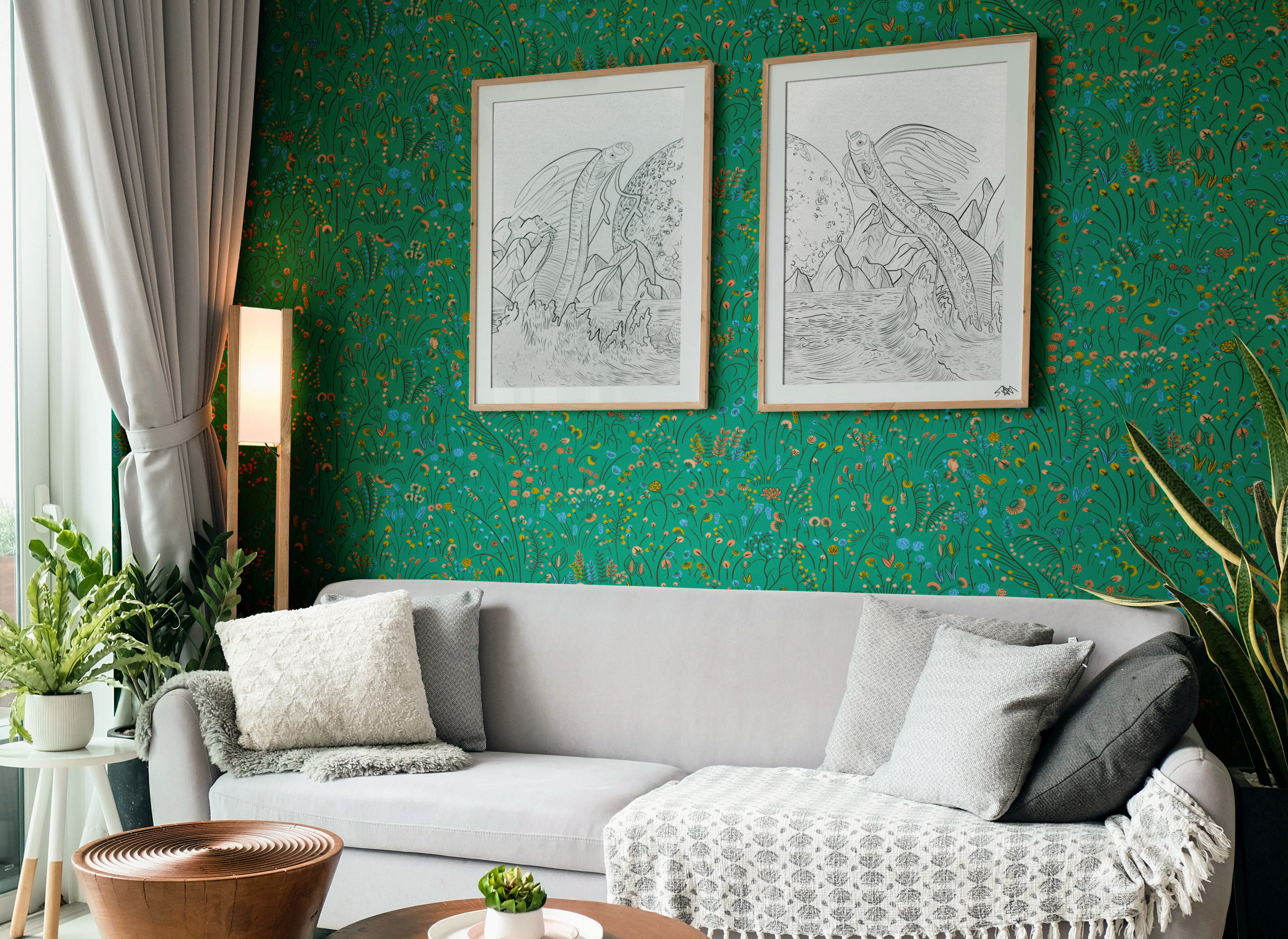 A cosy beige sofa positioned in front of a green flower meadow wallpaper.