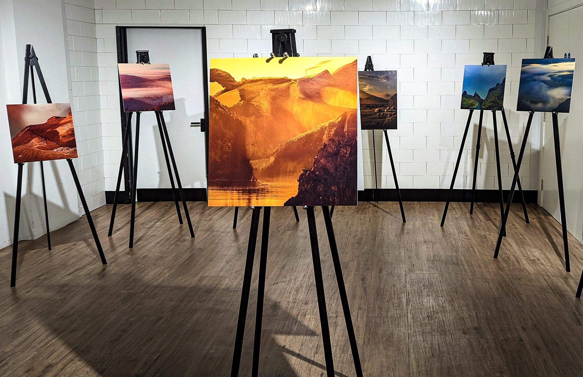 Canvases depicting AI art created by Sam Wilde in an gallery context.