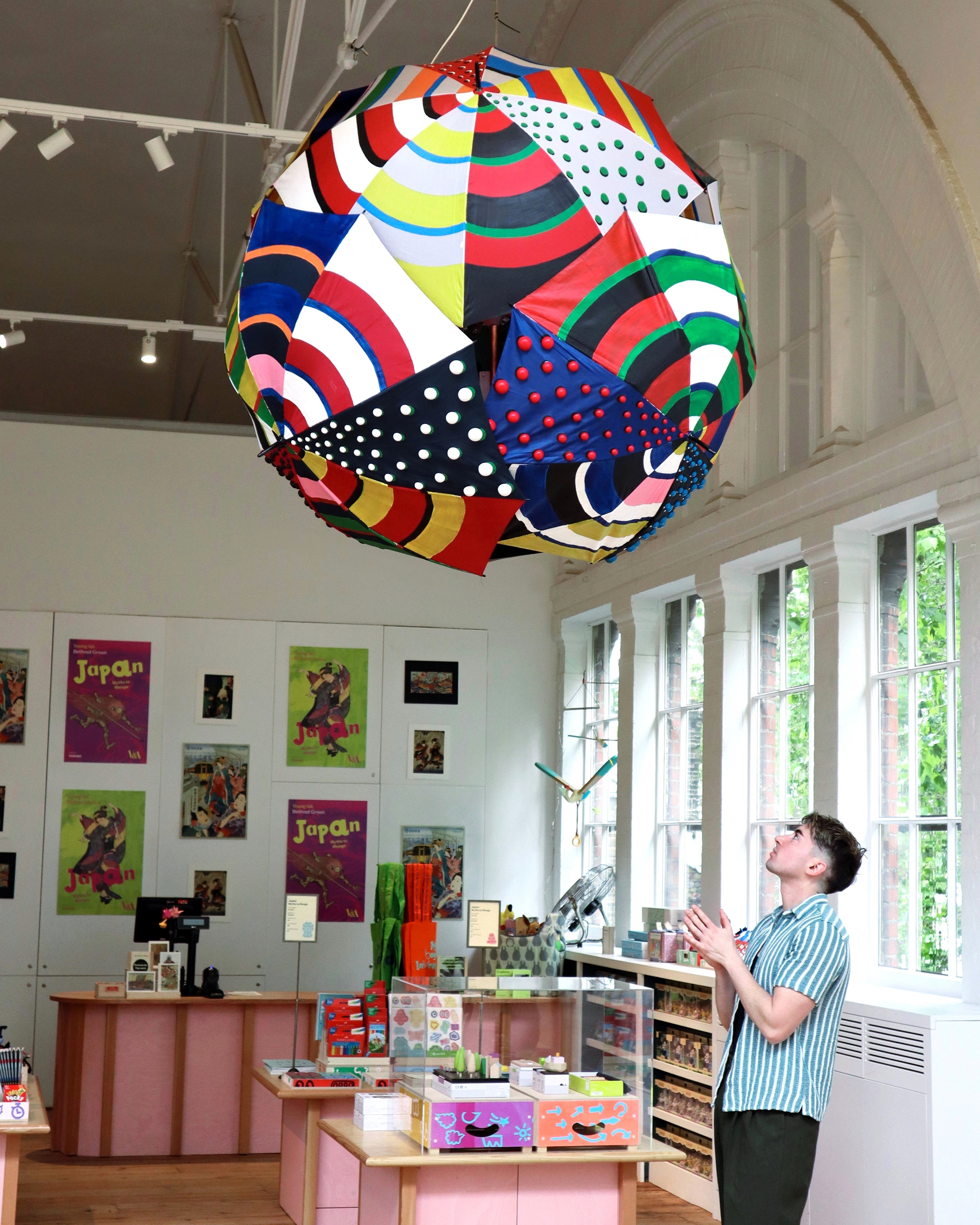 Sam Wilde looks up towards the umbrella sphere sculpture Deepstaria umbra that he created for an exhibition at the V&A.