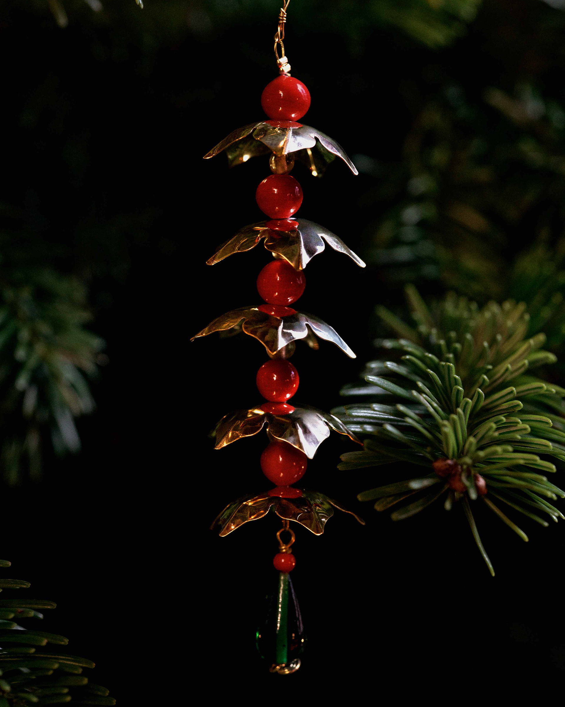 Detail of a brass and red glass ornament from Sam Wilde’s Poison of Eden collection for Svenskt Tenn, reflecting the design heritage of Josef Frank’s Poisons motif.