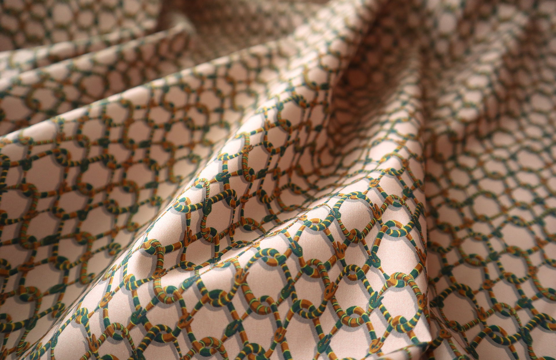 Soft cotton fabric showing the snake-themed pattern Vespertine Chain.