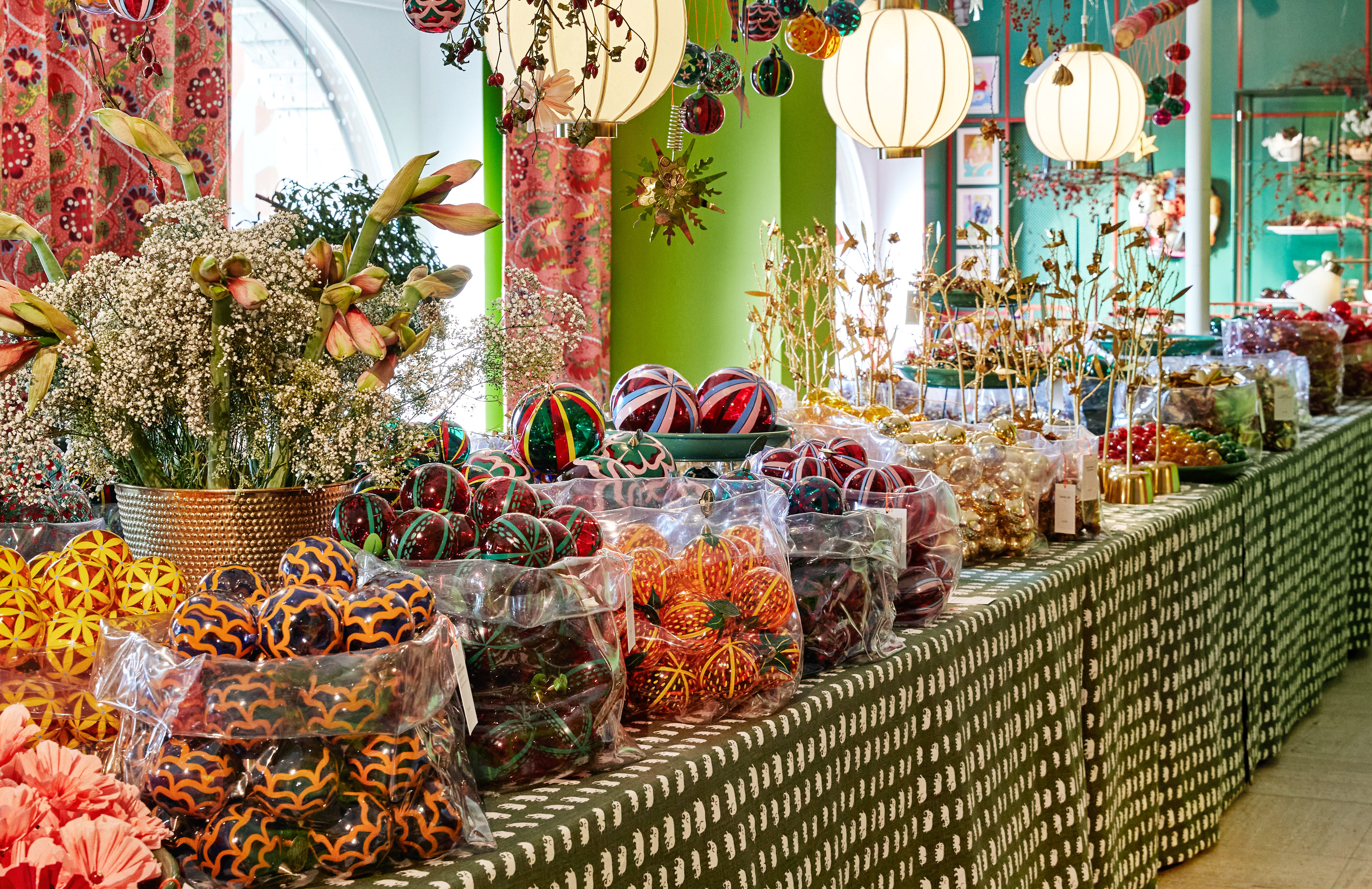Svenskt Tenn store at Christmas time showing glass fruit and flower baubles designed by Sam Wilde.