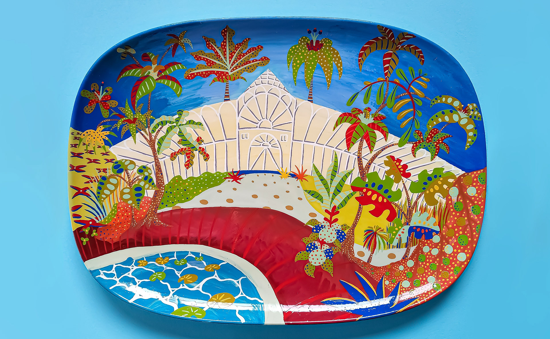 A large hand-painted ceramic plate depicting the outside of a greenhouse in abstract colours.