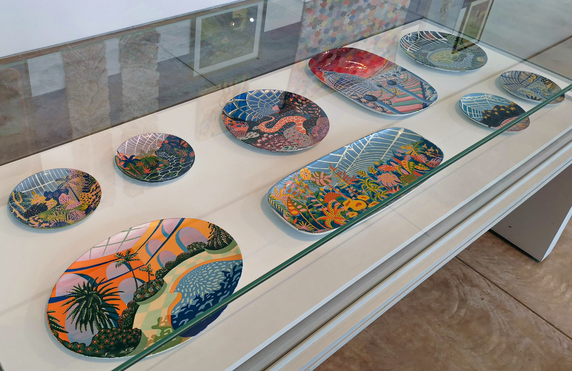 A glass cabinet in the Turner Contemporary displaying the Glasshouse ceramic collection painted by Sam Wilde.