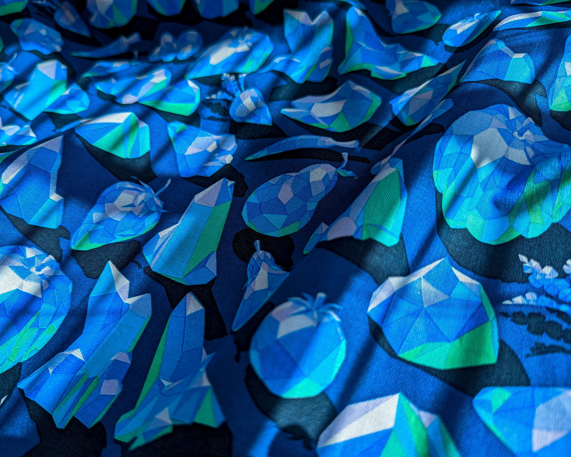 Photograph of 3D crystal fruits pattern printed onto a blue cotton fabric.