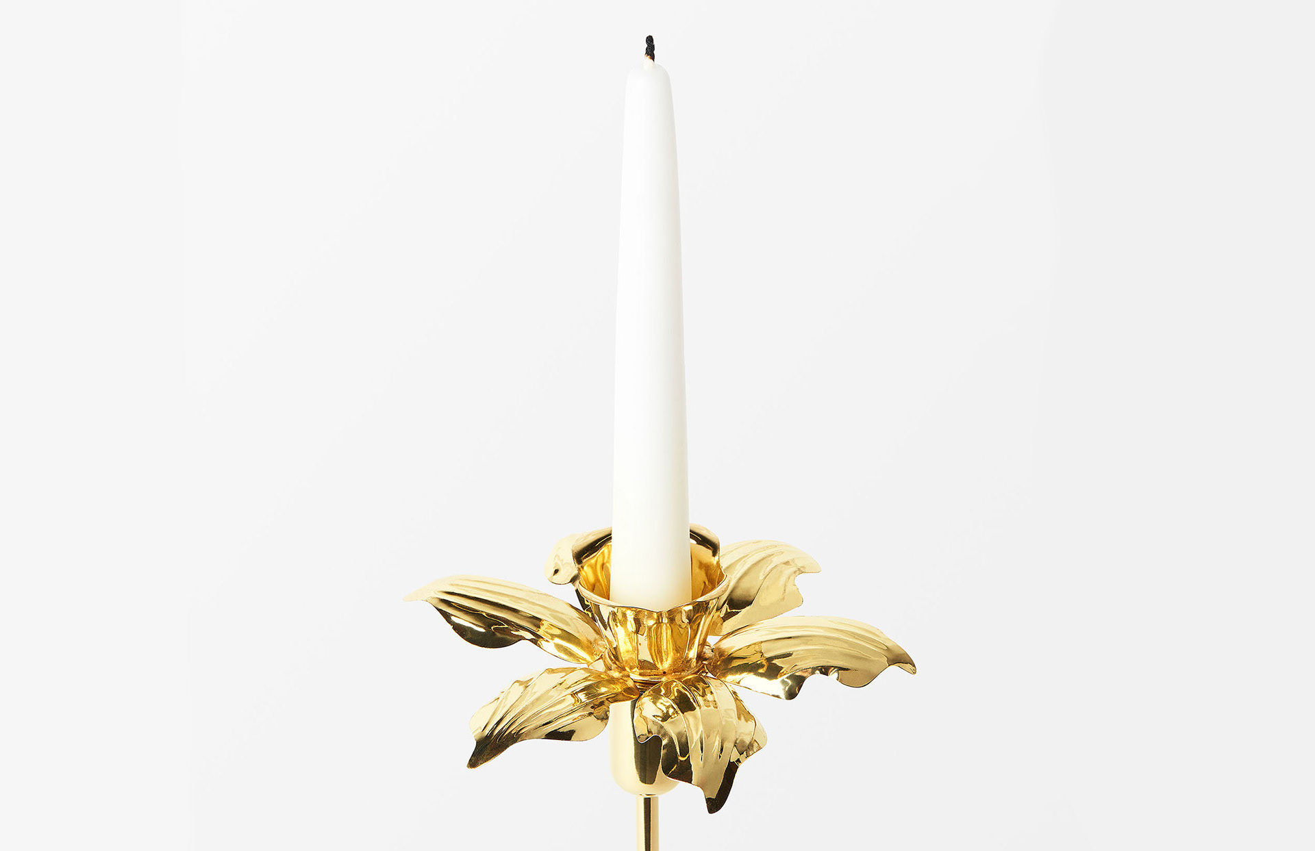 Product image of the brass daffodil candle ring designed by Sam Wilde.
