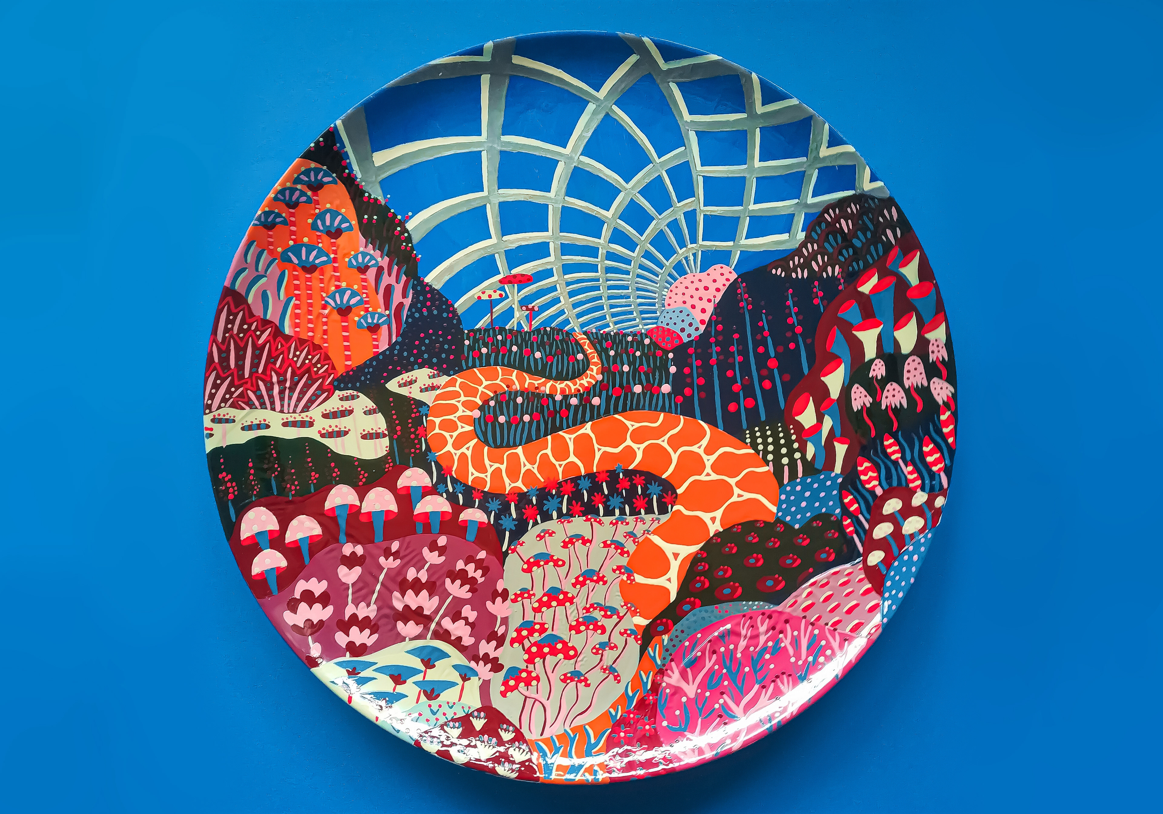 Hand-painted ceramic plate showing a strange world filled with blue, orange and pink mushrooms.