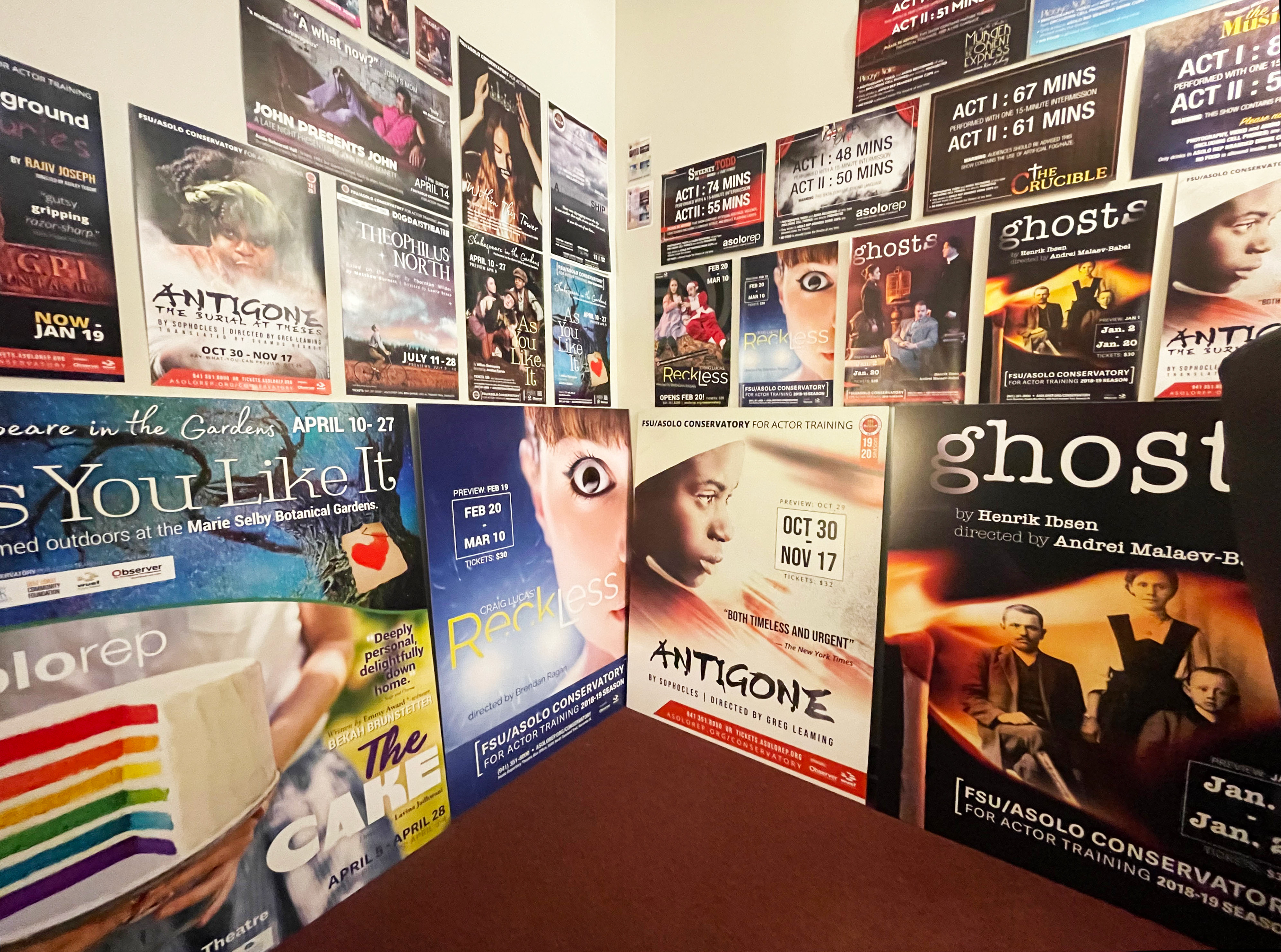 My office, full of posters/fliers/graphics I created, photographed prior to working from home during the pandemic.