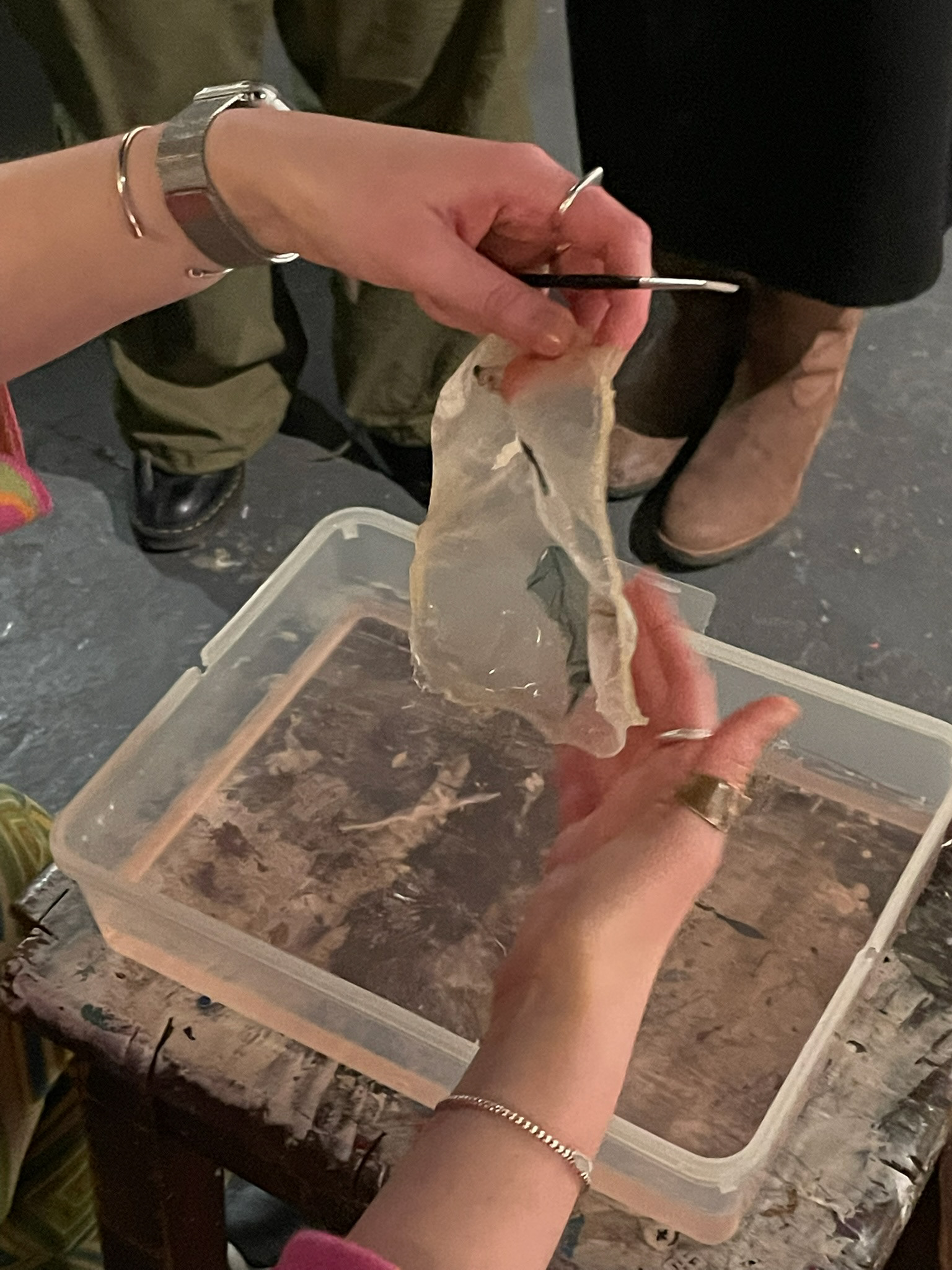 lifting bioplastic from water bath with emulsion lift on surface