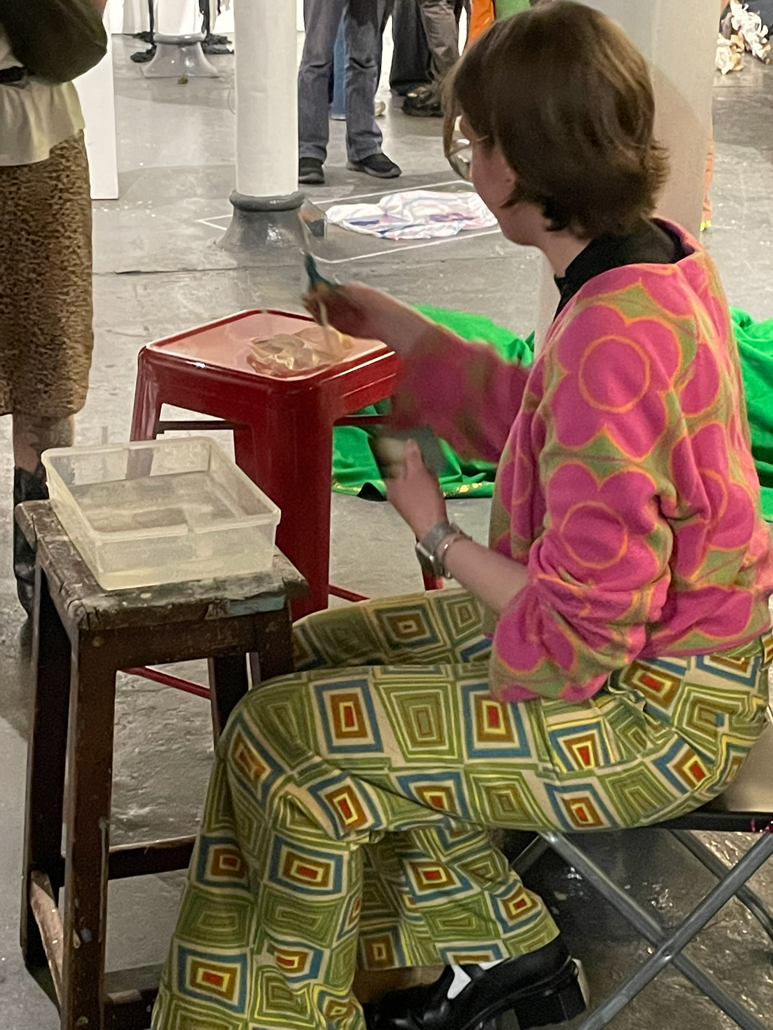 image of yasmin l jones making pieces duirng the exhibition using bioplastic and polaroids