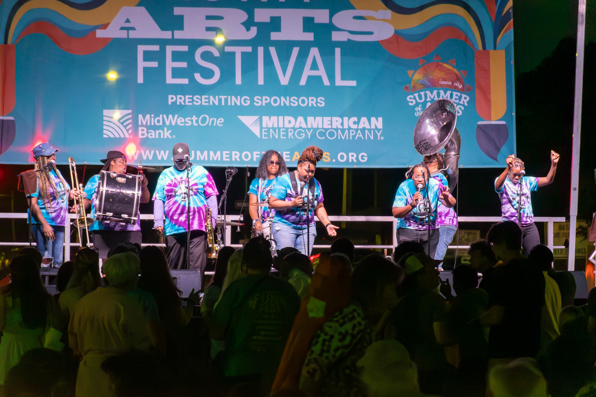 IOWA CITY, IOWA – JUNE 6, 2025: The Original Pinettes Brass Band closes out their Iowa Arts Festival performance in full force as the audience dances under the night sky. With every note, the all-female group affirmed their place as queens of New Orleans brass.