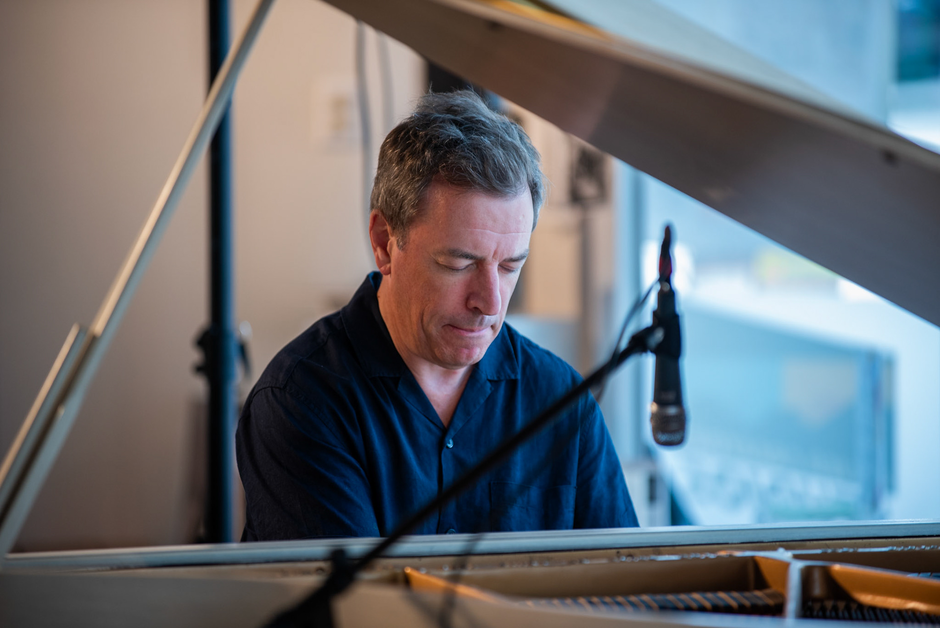 Pianist Matthew Fries performs an intimate solo set at the Burlington Art Center, captivating the audience with a mix of originals and jazz classics during the Burlington Jazz Festival on July 26, 2025.
