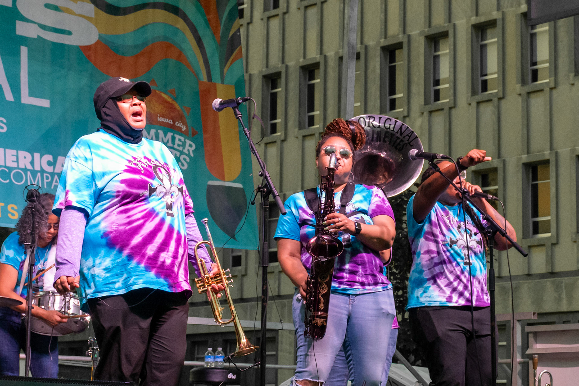 IOWA CITY, IOWA – JUNE 6, 2025: Careese Williams, Natasha Harris, and Veronique Dorsey of The Original Pinettes Brass Band showcase the band’s layered sound and chemistry at the Iowa Arts Festival. With brass, vocals, and energy in full swing, the group delivered a standout performance.