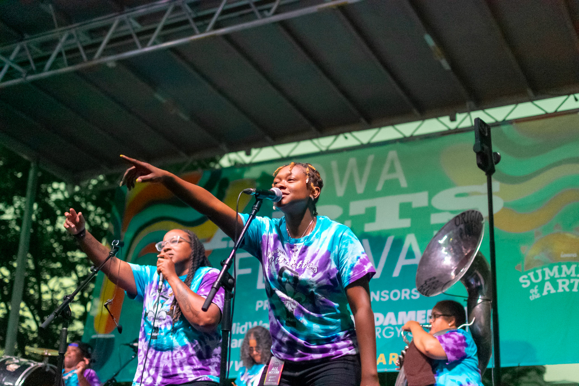 IOWA CITY, IOWA – JUNE 6, 2025: Jazz Henry and Veronique Dorsey, both trumpet players and vocalists for The Original Pinettes Brass Band, engage the audience during a lively set at the Iowa Arts Festival. Their dynamic chemistry and commanding stage presence brought the spirit of New Orleans to downtown Iowa City.
