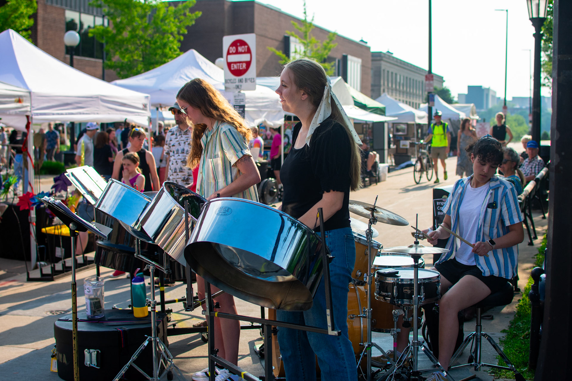 IOWA CITY, IOWA/UNITED STATES – JUNE 6, 2025: Pandelirium Steel Band performs on Clinton Street featuring University of Iowa alumni Ava Thopskie, McKenna Blenk, and Anni Perez-Brennan.
