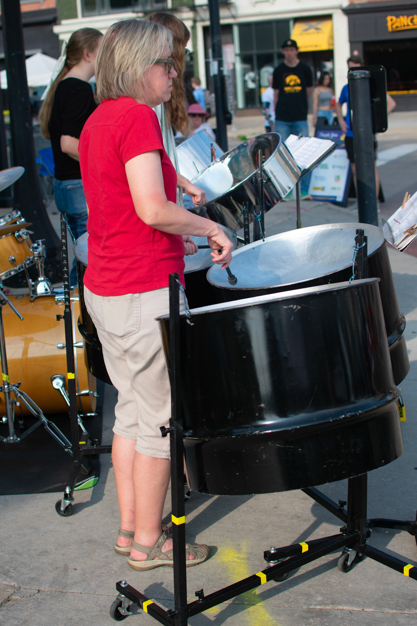 IOWA CITY, IOWA/UNITED STATES – JUNE 6, 2025: Ginny Armstrong of the Pandelirium Steel Band performs during the Iowa Arts Festival on Clinton Street.