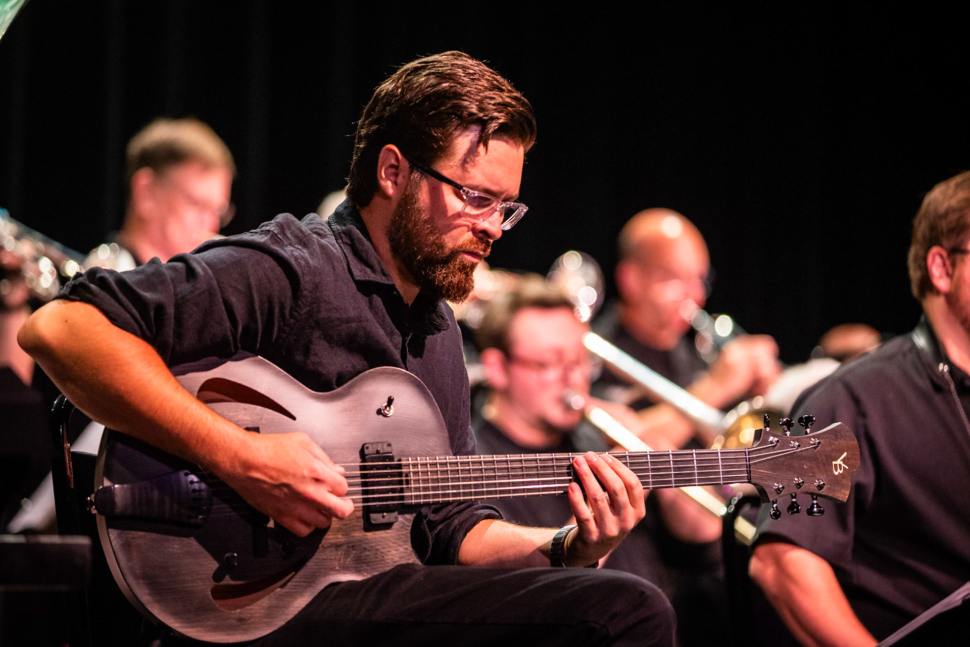 Guitarist Joel Ream performs with the Pete Ellman Big Band, adding rich textures to the ensemble’s brassy sound during the Burlington Jazz Festival on July 26, 2025.
