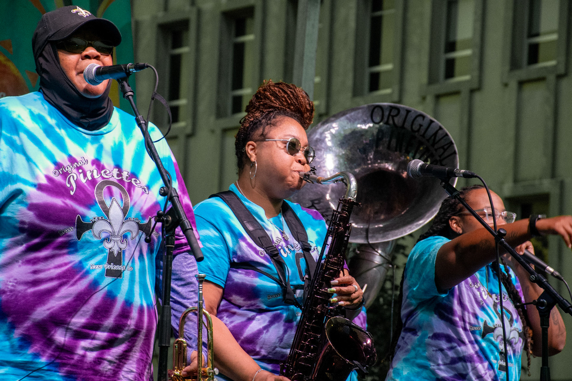 IOWA CITY, IOWA – JUNE 6, 2025: Trumpet player Careese Williams (left) joins bandmates on vocals as The Original Pinettes Brass Band delivers a high-powered set at the Iowa Arts Festival. The group’s dynamic brass lineup and engaging performance brought the crowd to life.