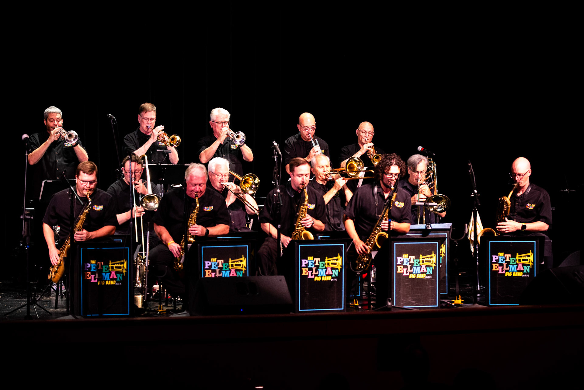 The horn section of the Pete Ellman Big Band lights up the Capitol Theater stage, with founder Pete Ellman (top right, trumpet) leading the brassy charge during the Burlington Jazz Festival.