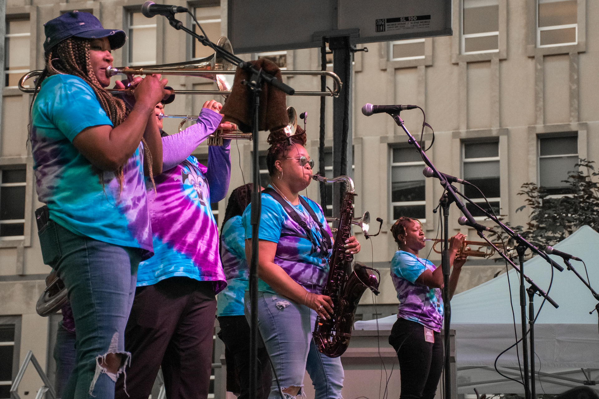 IOWA CITY, IOWA – JUNE 6, 2025: From left to right, Dionne Harrison, Careese Williams, Natasha Harris, and Jazz Henry of The Original Pinettes Brass Band perform in full stride at the Iowa Arts Festival. Their wall of sound blended harmony, rhythm, and power, drawing cheers from the Clinton Street crowd.