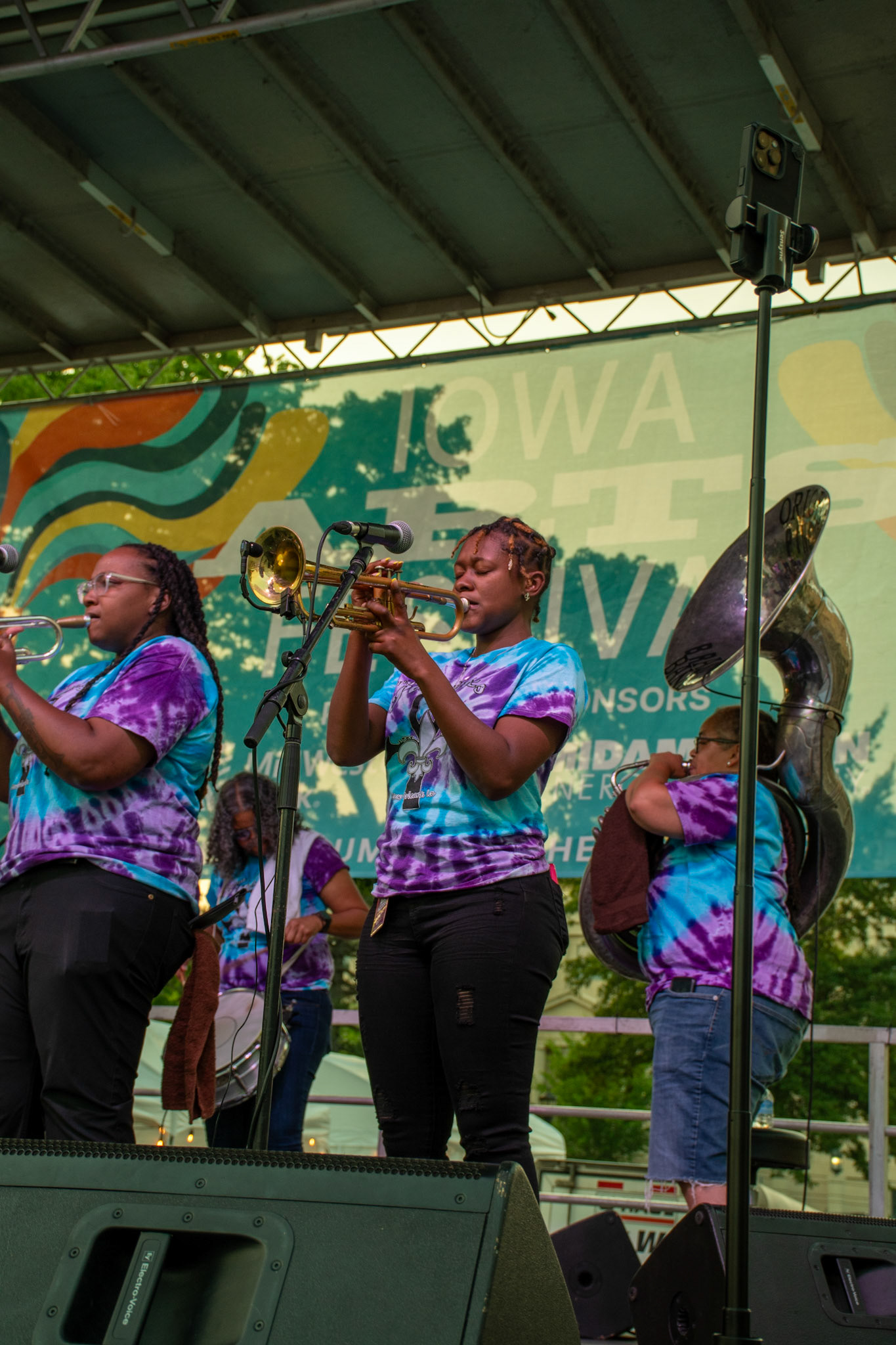 IOWA CITY, IOWA – JUNE 6, 2025: Jazz Henry delivers a focused trumpet solo alongside fellow band member Veronique Dorsey during The Original Pinettes Brass Band’s performance at the Iowa Arts Festival. The group’s soulful brass sound echoed through downtown, captivating the early evening crowd.