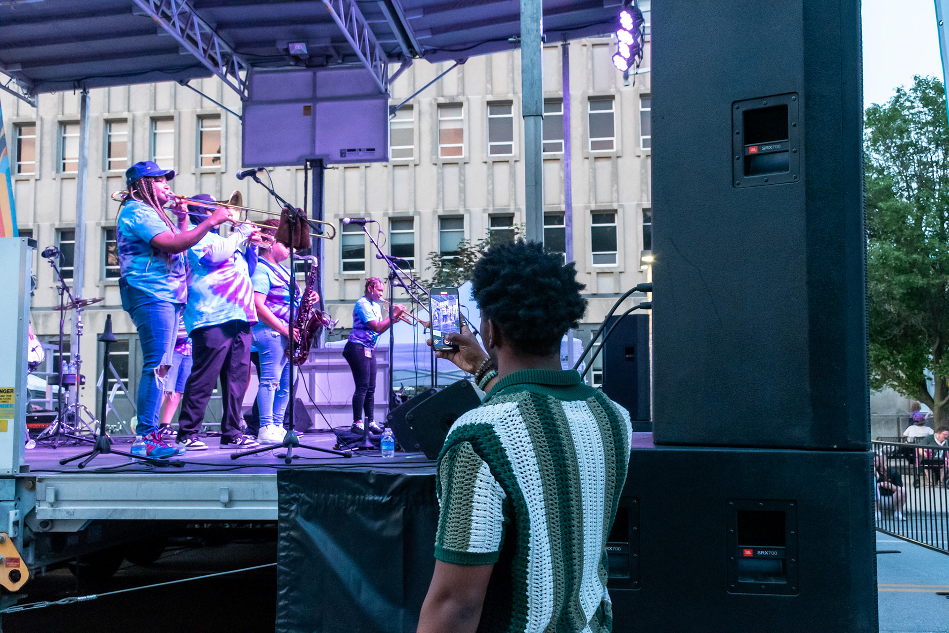 IOWA CITY, IOWA – JUNE 6, 2025: Jorion Dawson, tenor saxophonist for Tomar and the FCs, captures a moment backstage as The Original Pinettes Brass Band lights up the stage. The acclaimed all-female brass group drew admiration from fellow musicians and fans alike during the Iowa Arts Festival.