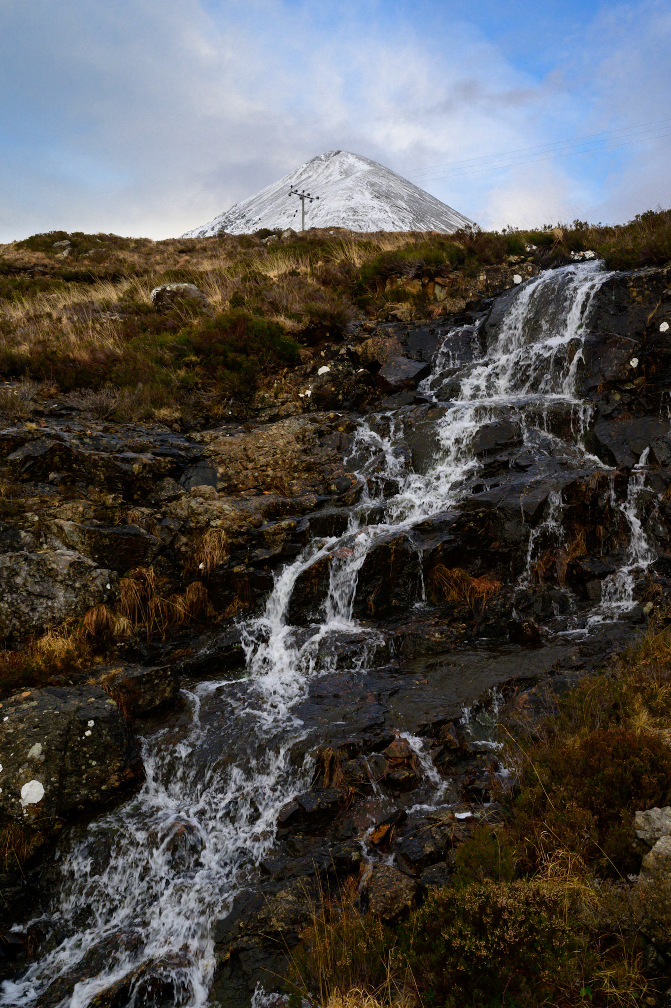 A snowmelt stream rolls down a drop in the early Skye spring.