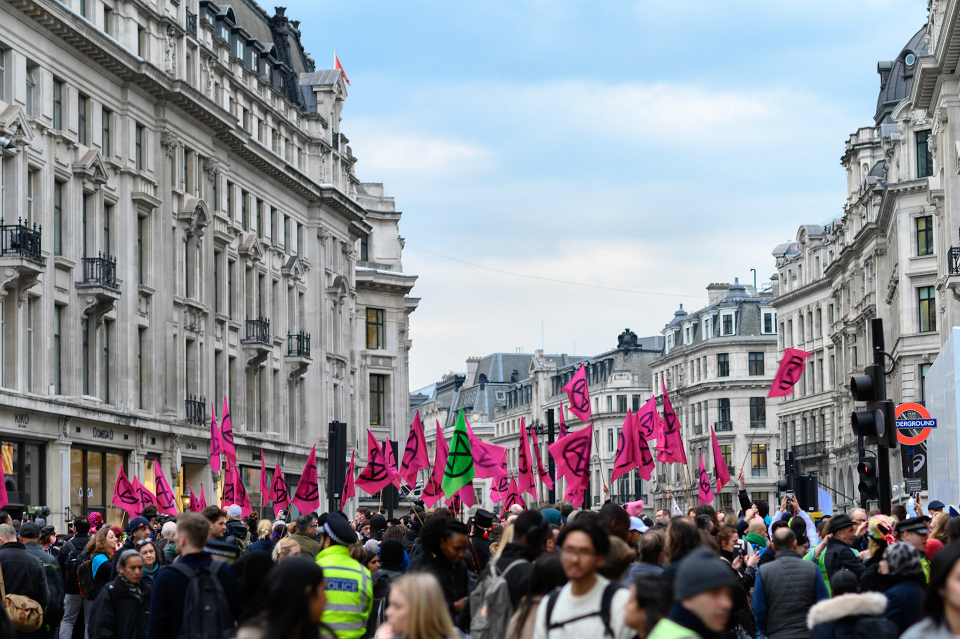Extinction Rebellion flags crowd the regimented facades of Regent Street.