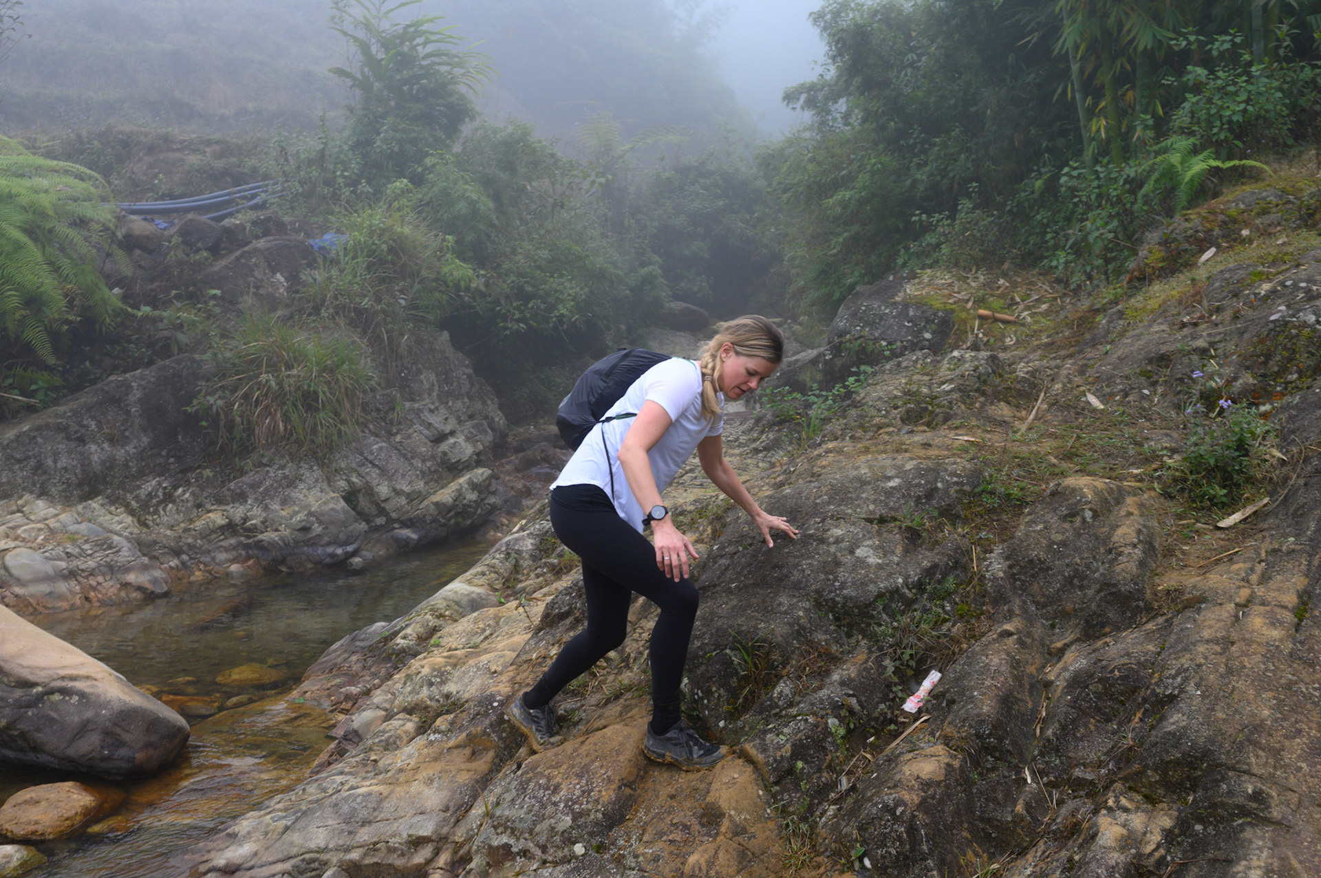 Sheryl scrambling on a river crossing