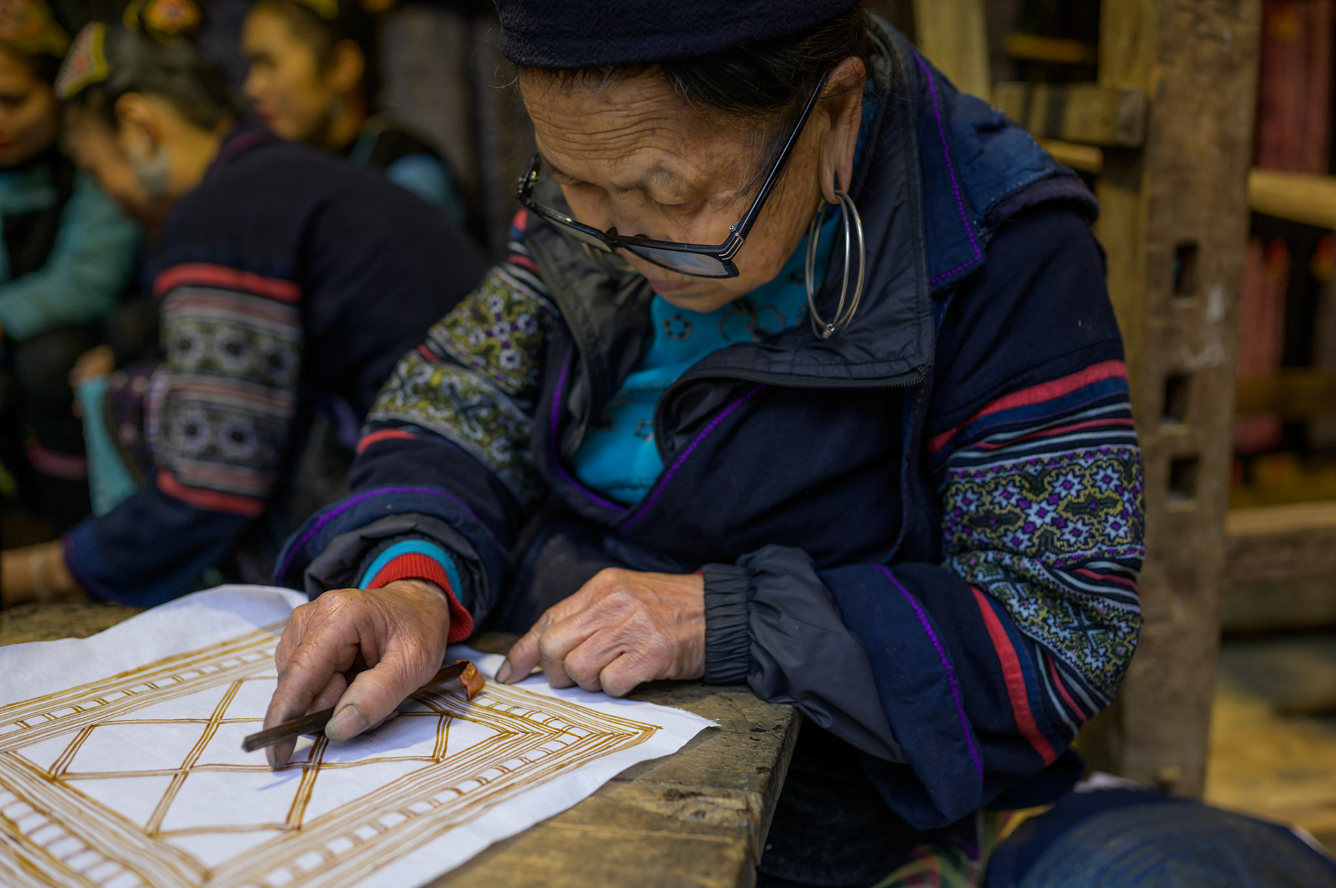 Cat Cat village showcases traditional agruculture and arts for tourists.
This woman inks a traditional design.
