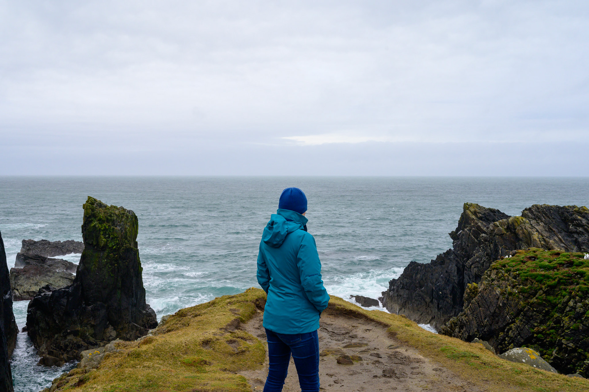 Sheryl looking out at the Atlantic from the Ness lighthouse on a wild and windy day