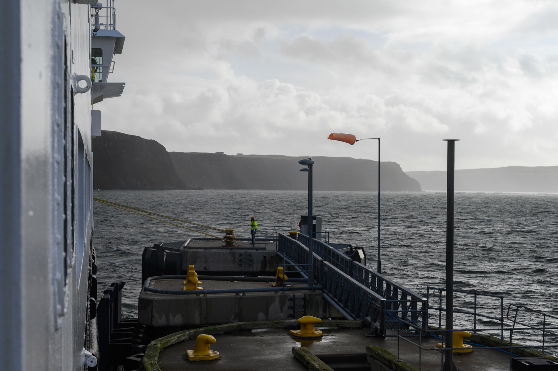 The windsock at Uig port blowing horizontal, prior to sailing to Tarbet on Lewis. 
The bad weather of the last few days has just cleared enough to allow the ferry to resume its route between Uig and Tarbet.