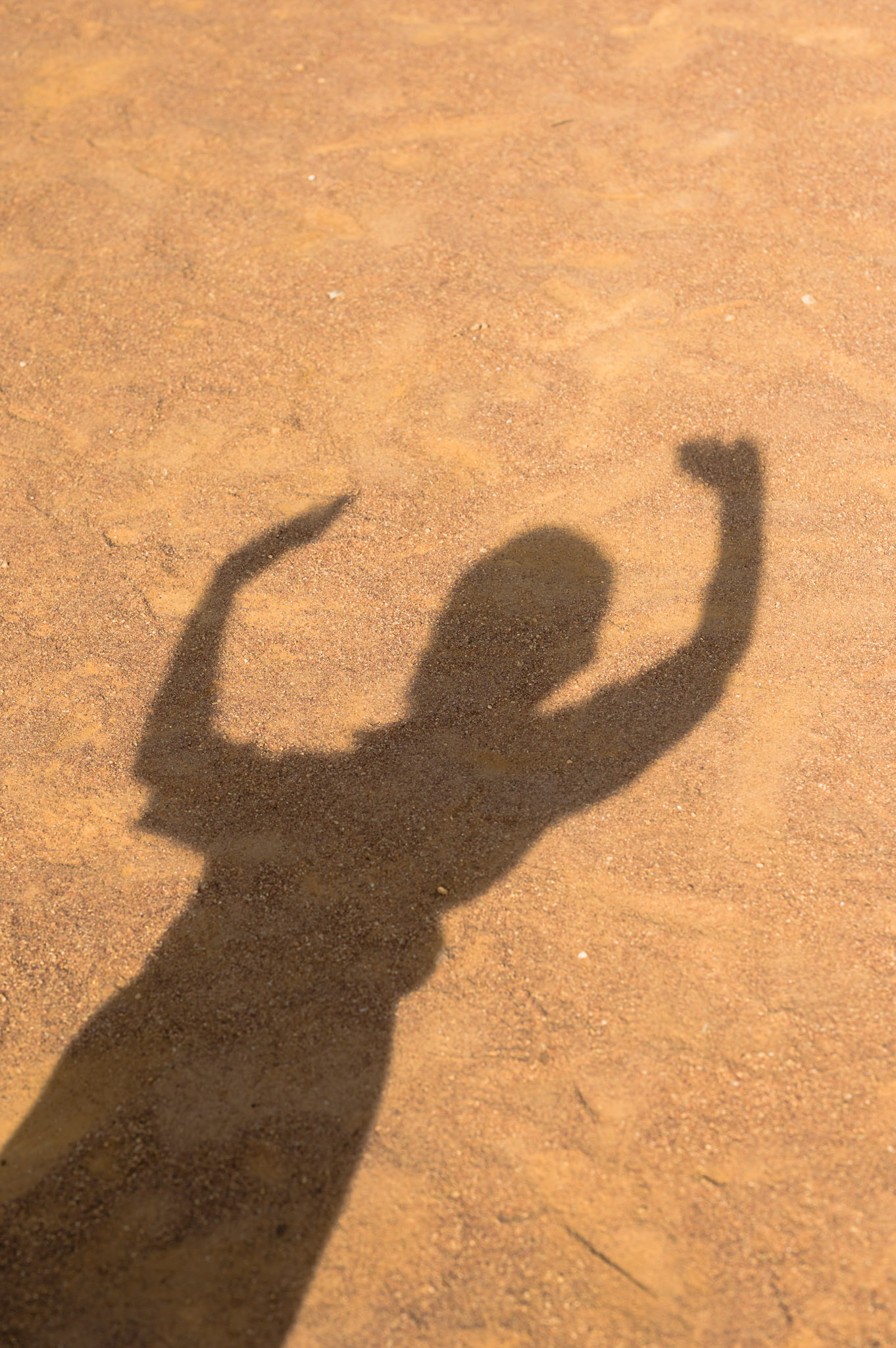 Children raise their hands in the circle before class.Teachers form the children into a circle before classes. The children hold hands, sing, and clap.Angelique Mukankiko, the head teacher, says that children starting at the ECD are often too frightened of other children to hold hands, but quickly open up and "become more loving of one another".