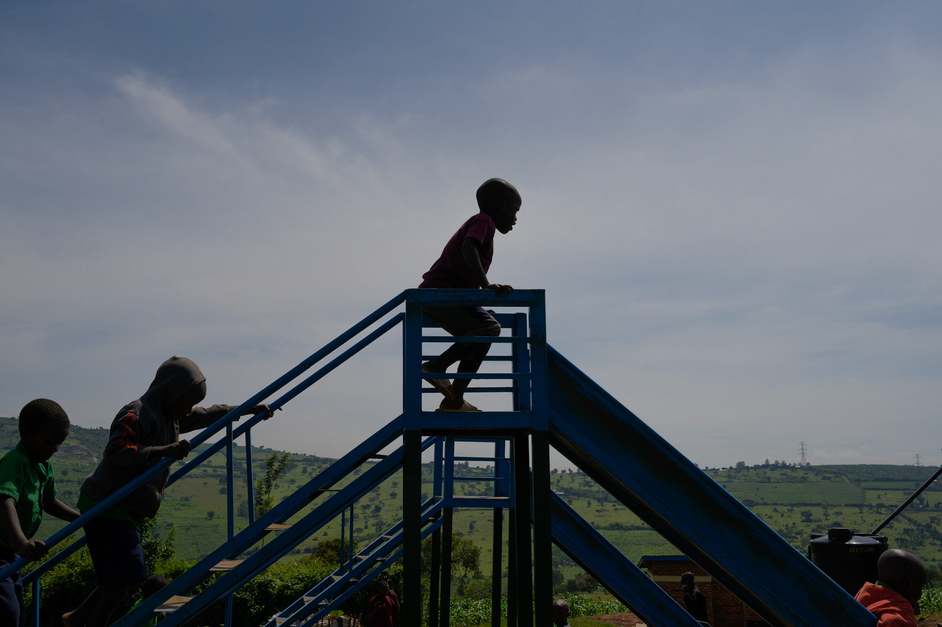 Children race up for turns on the slide.