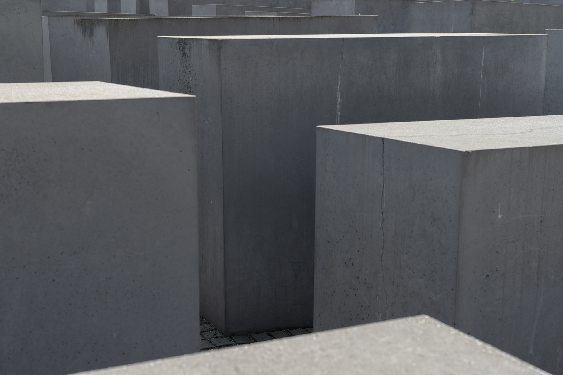 According to the designer, The Berlin Jewish Memorial  is not meant to signify anything. A person entering it is free to find their own meaning. For me, walking the canyons and looking over the expanse of grey blocks quickly brought a deeply contemplative slightly claustrophobic mood of insignificance into which the reason for the memorial could expand into consciouness.