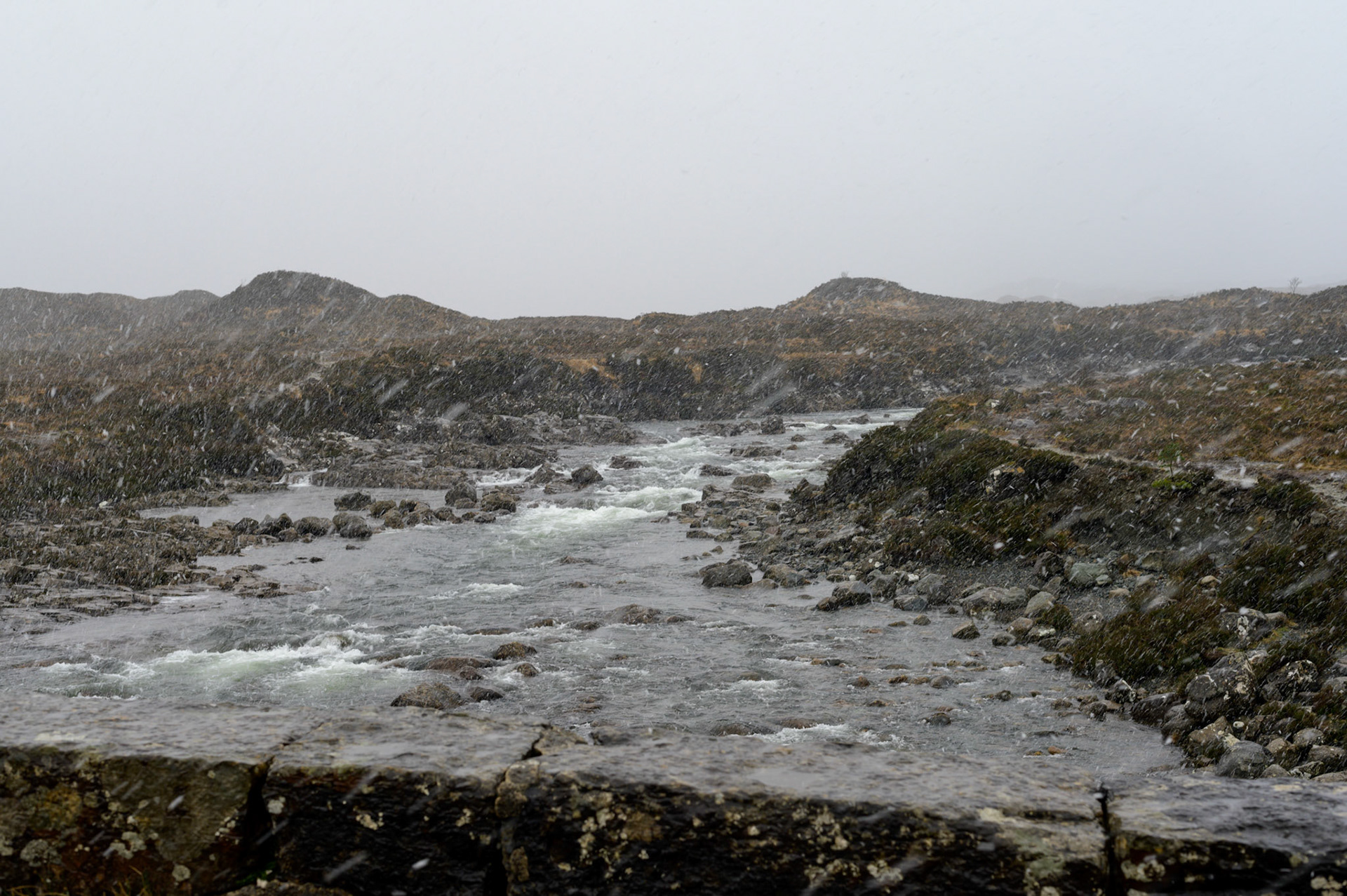 Wet snowflakes veil the river through Sligachan.