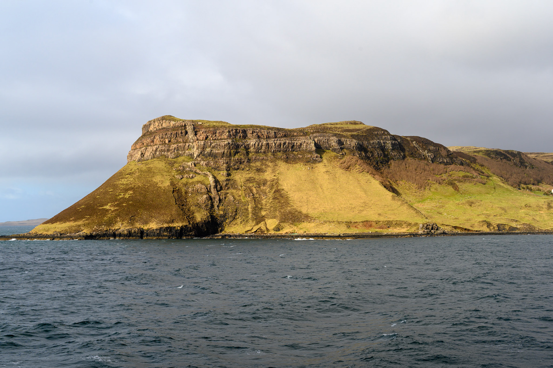 A rare splash of sun on Uig headland just as we sail to Tarbet on Lewis.