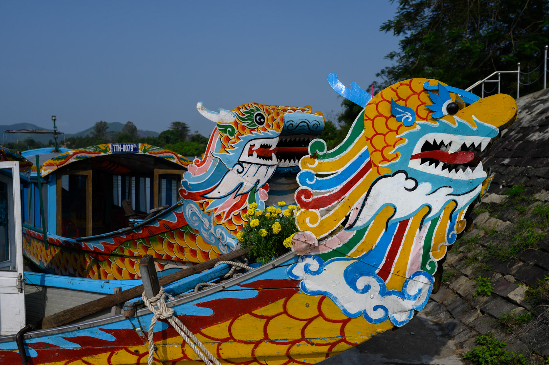 Dragon headed tourist boats at a wharf on the Perfume River