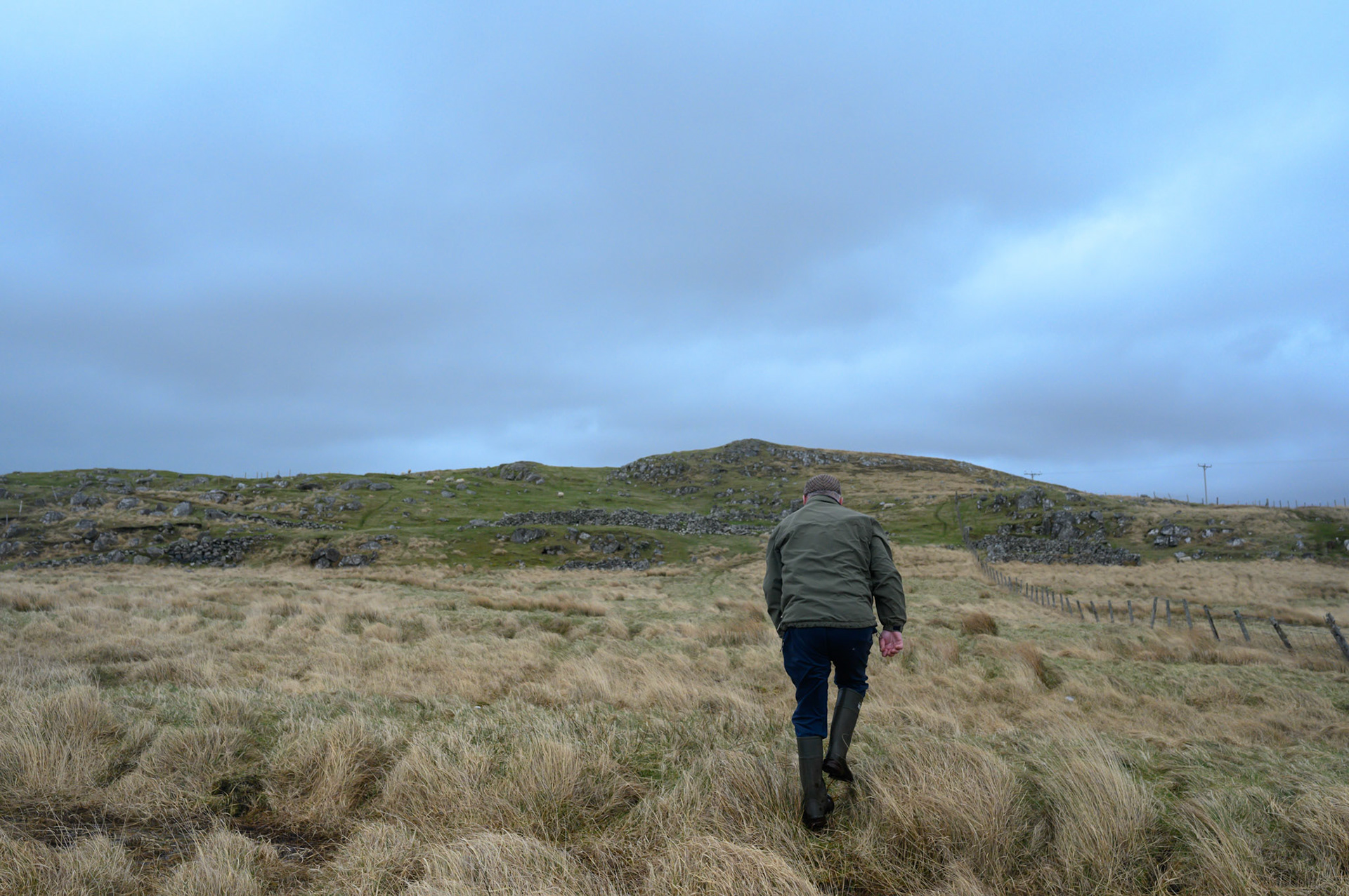 Robert leans into the wind coming off the atlantic. Anywhere else this would be a gale. He is going to check on the new lamb at the back of his croft.