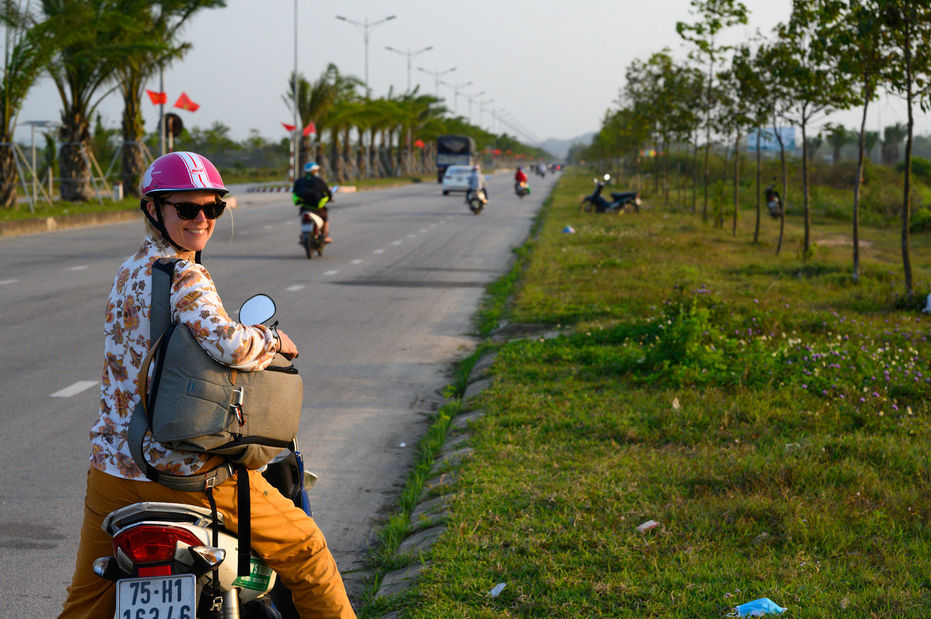 Sheryl on our hired scooted along the road from Hue.