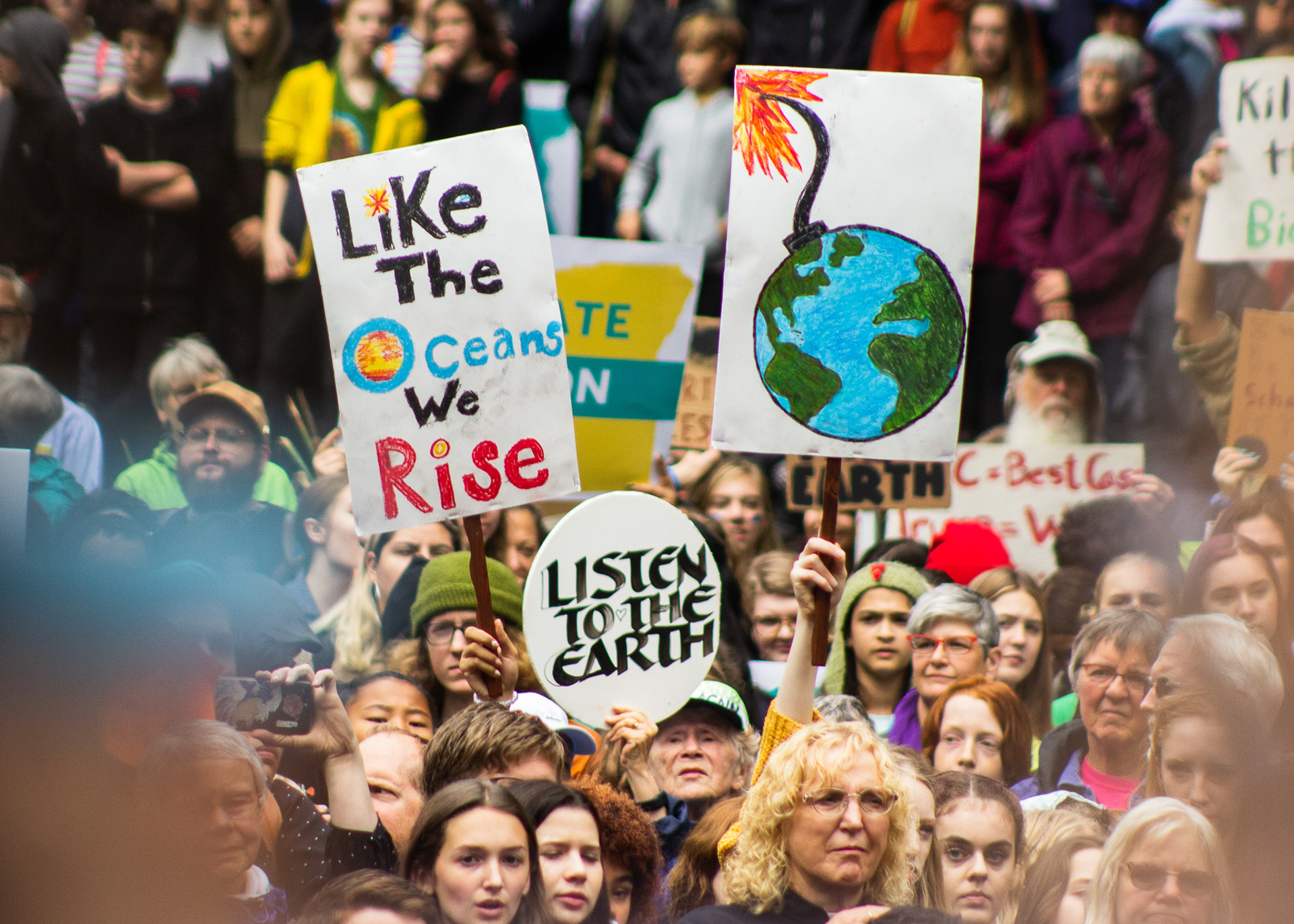 People wave handmade signs at the Global Climate Strike in Portland on September 20, 2019.