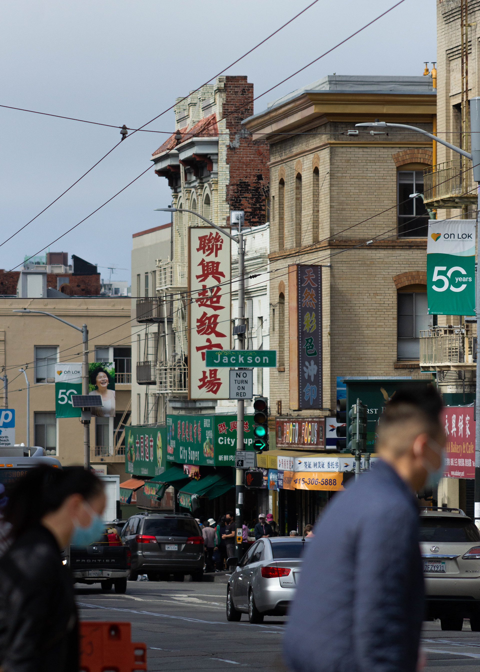Pedestrians cross Stockton Street in Chinatown.