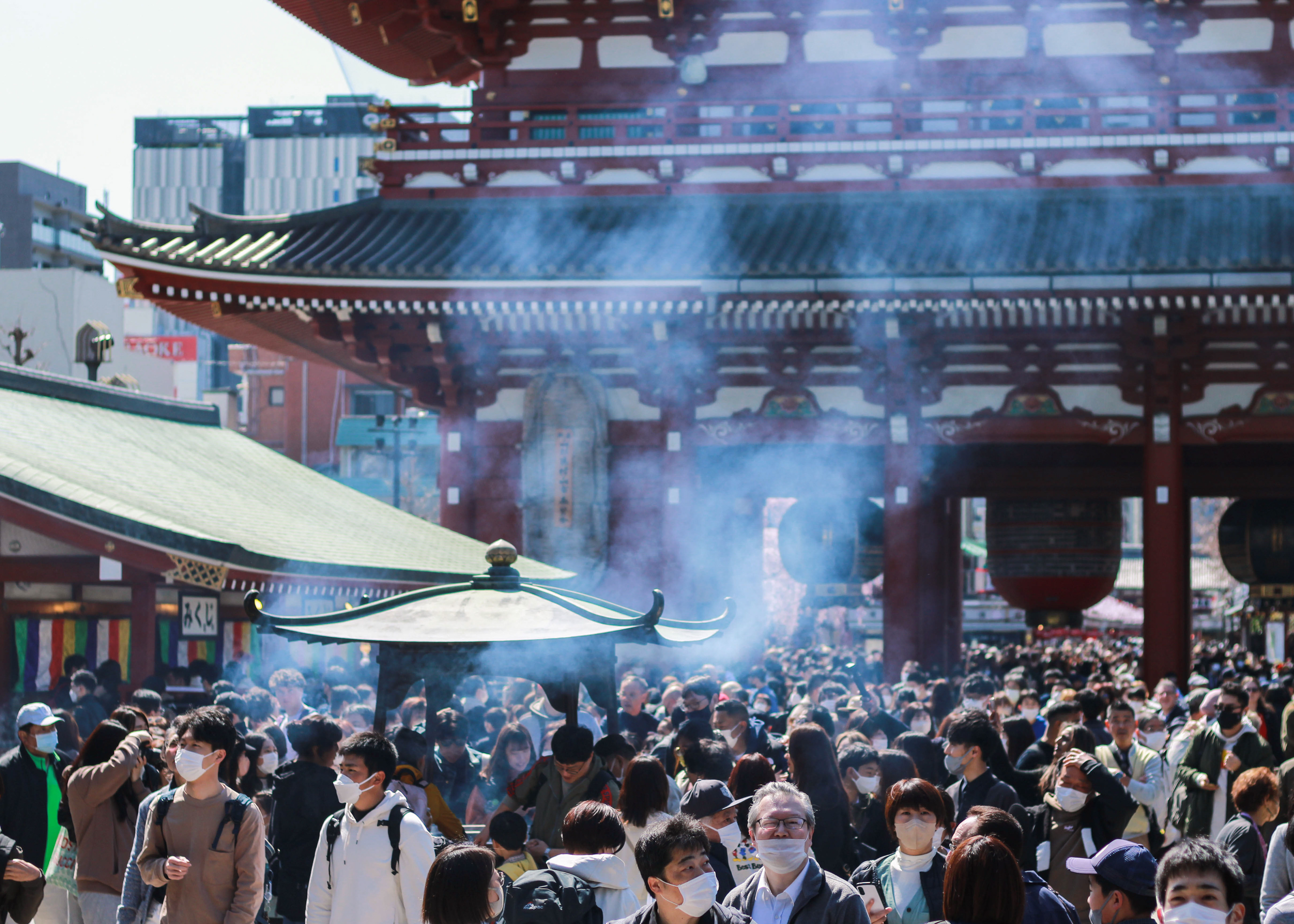 Crowds of people gather at Sensoji Temple in Tokyo's Asakusa District.