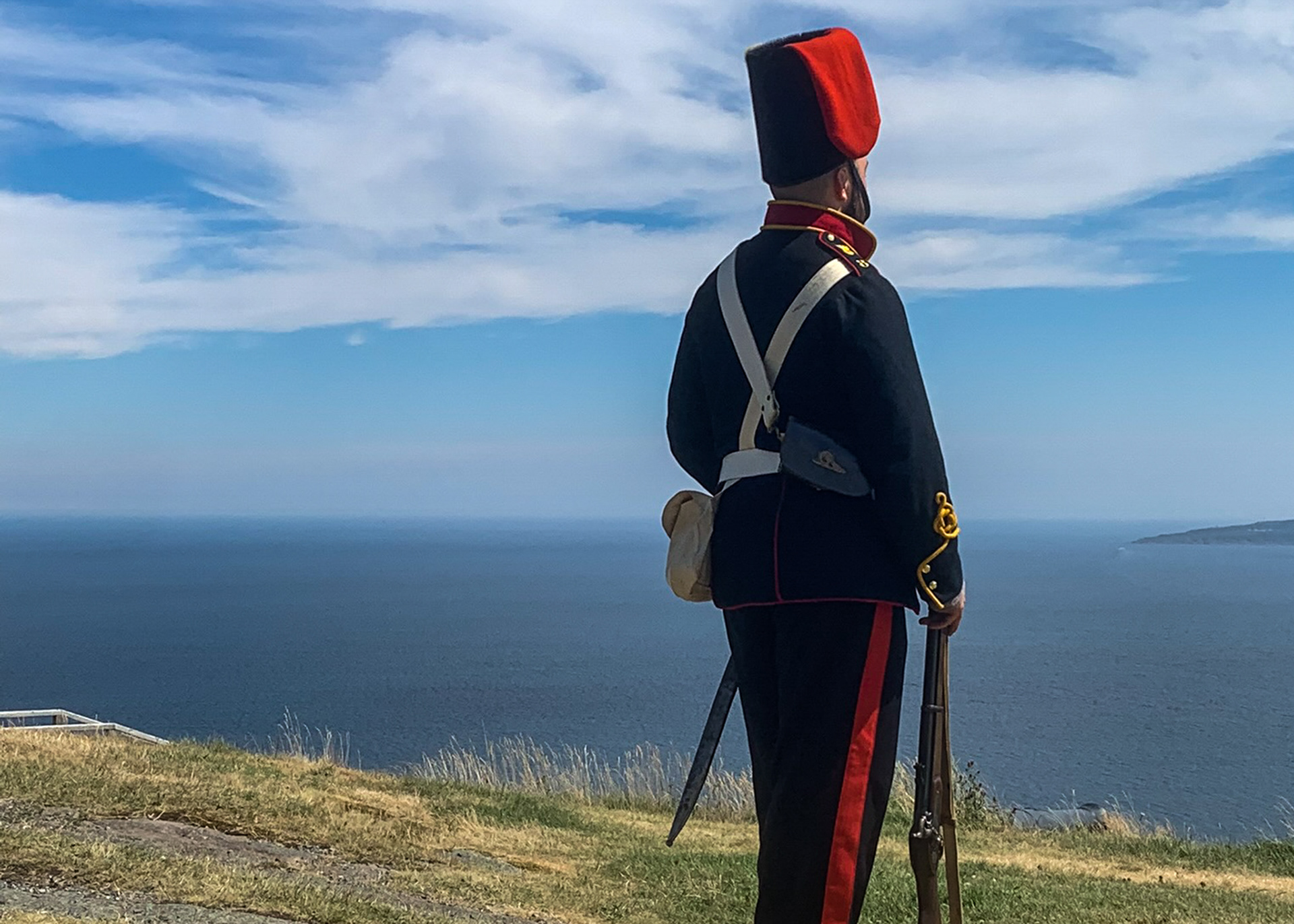 Soldier posing looking over the vast ocean from Signal Hill