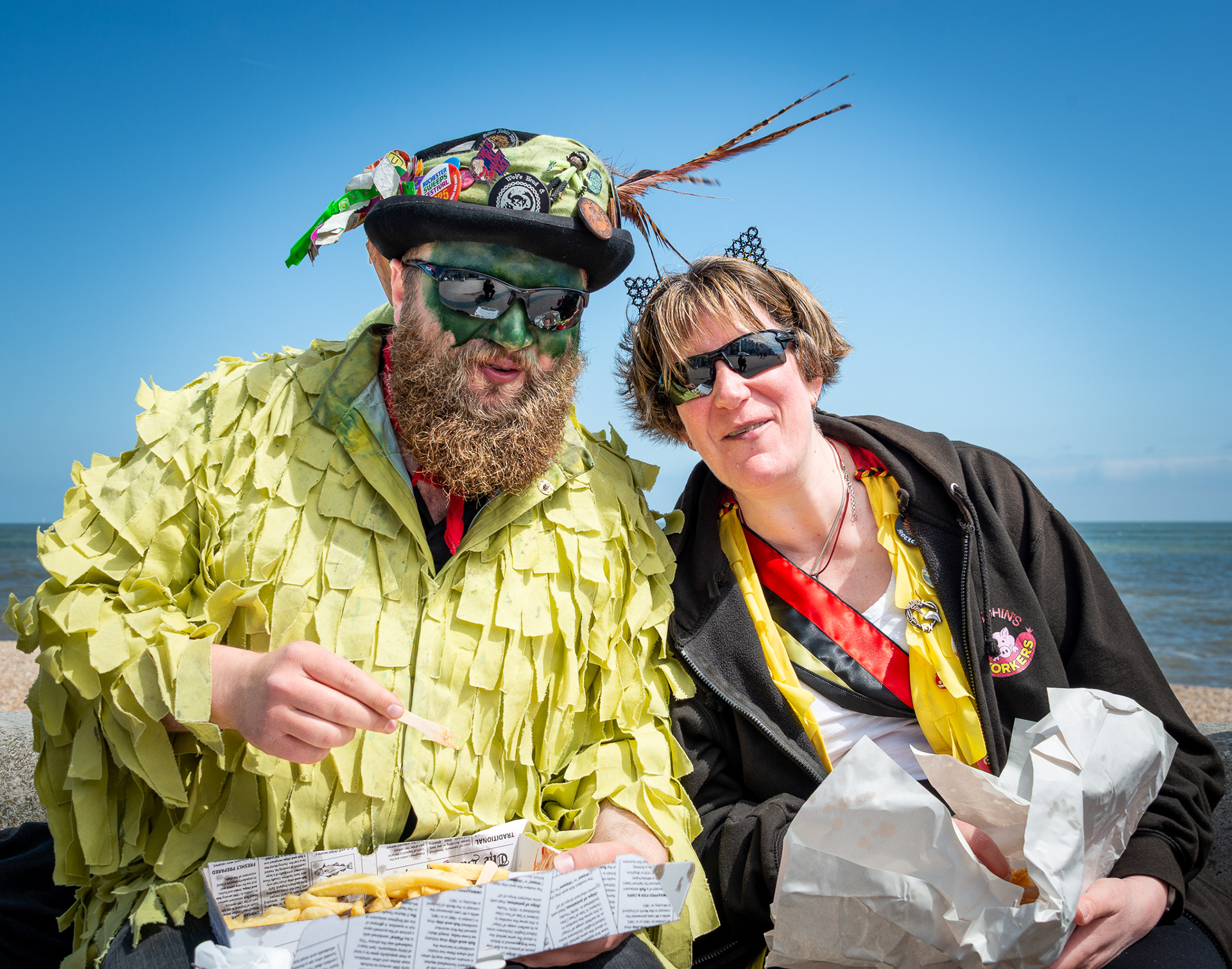 Will, a musician and Helen, a nurse enjoying fish and chips on Deal seafront. Will and Helen are part of a visiting Morris troupe,17th May, 2025. 