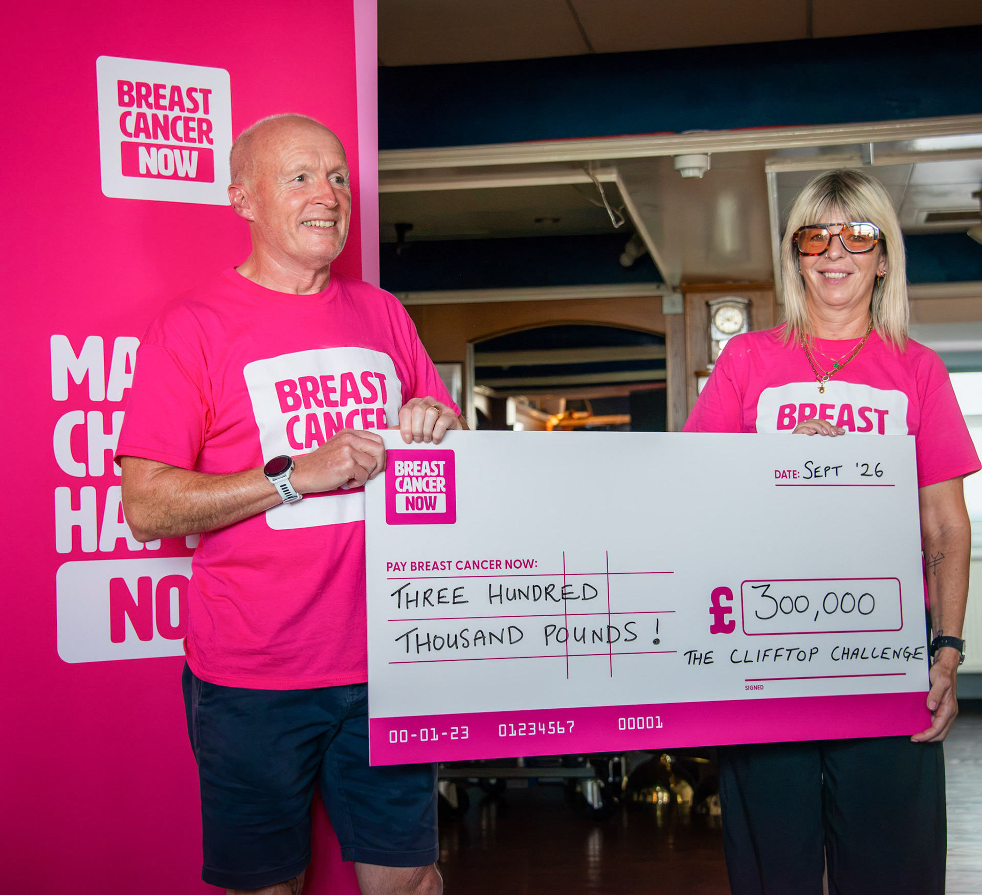 Chantelle and her husband Phil, handing over a cheque for an incredible £300,000, raised by the Clifftop Challenge, to Breast Cancer Now. Royal Marines Association Club, 27th September, 2026. 
