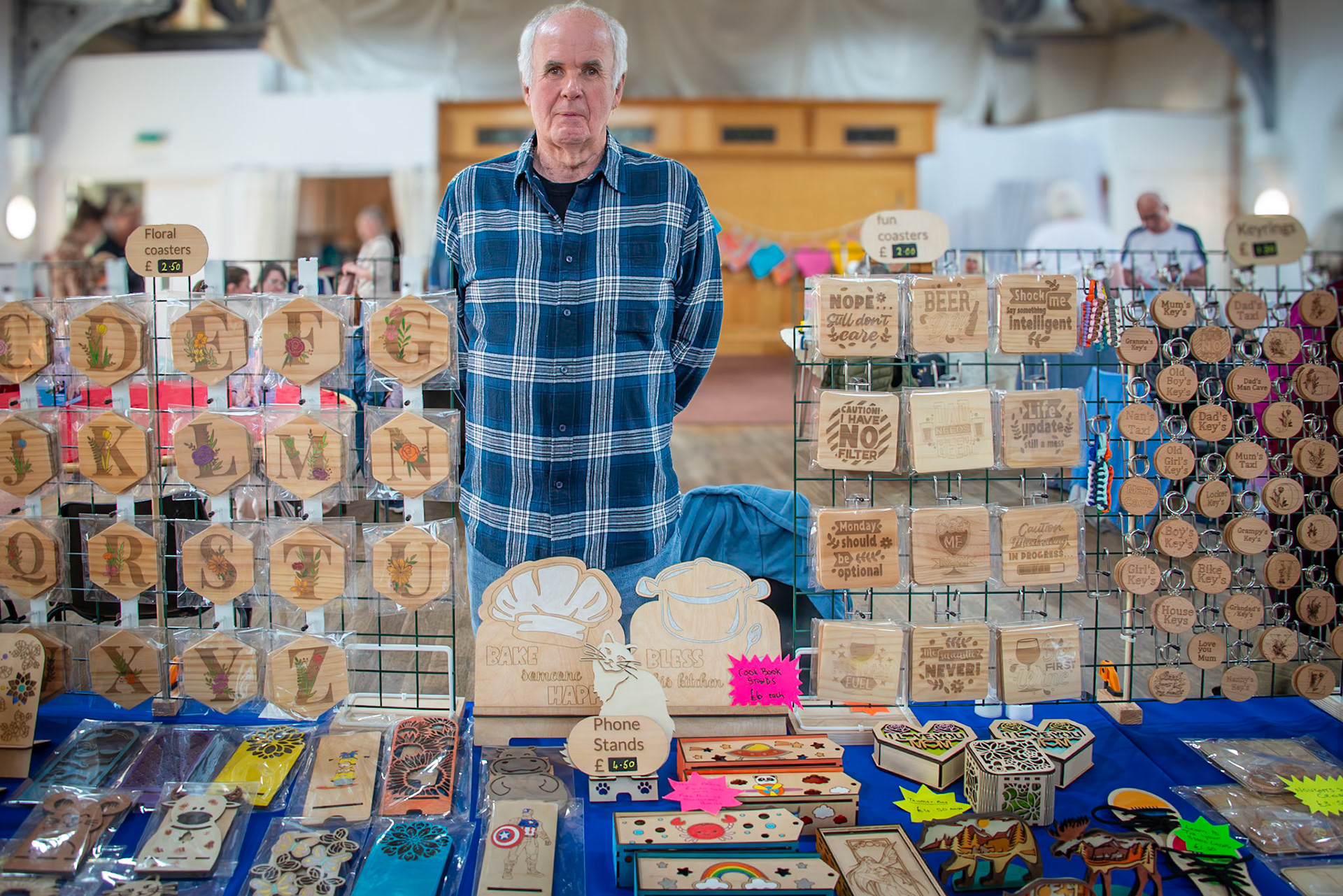 Derek, a laser wood carver and illustrator. Craft Fair for the Leaps and Bounds Community Project, The Landmark Centre, 12th April, 2025. The project promotes independence and provides skills for adults with learning disabilities.