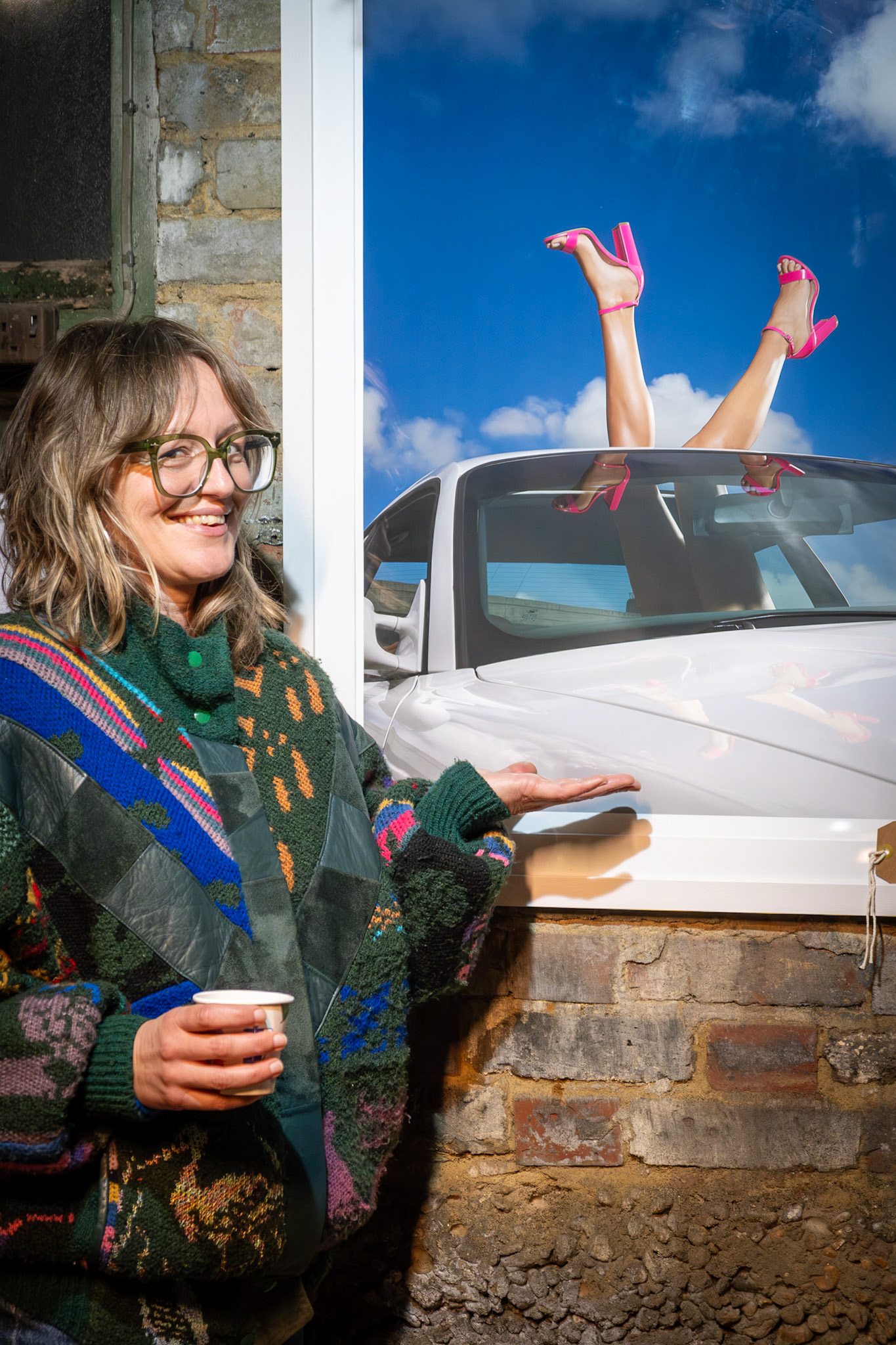 Carly, a yoga teacher in Deal with her picture, created by Rob Ashton Brown, and on loan for the Bygga Bo Hygge Pop Up at The Green Garage, Station Road, Walmer tonight, 4th December, 2025.