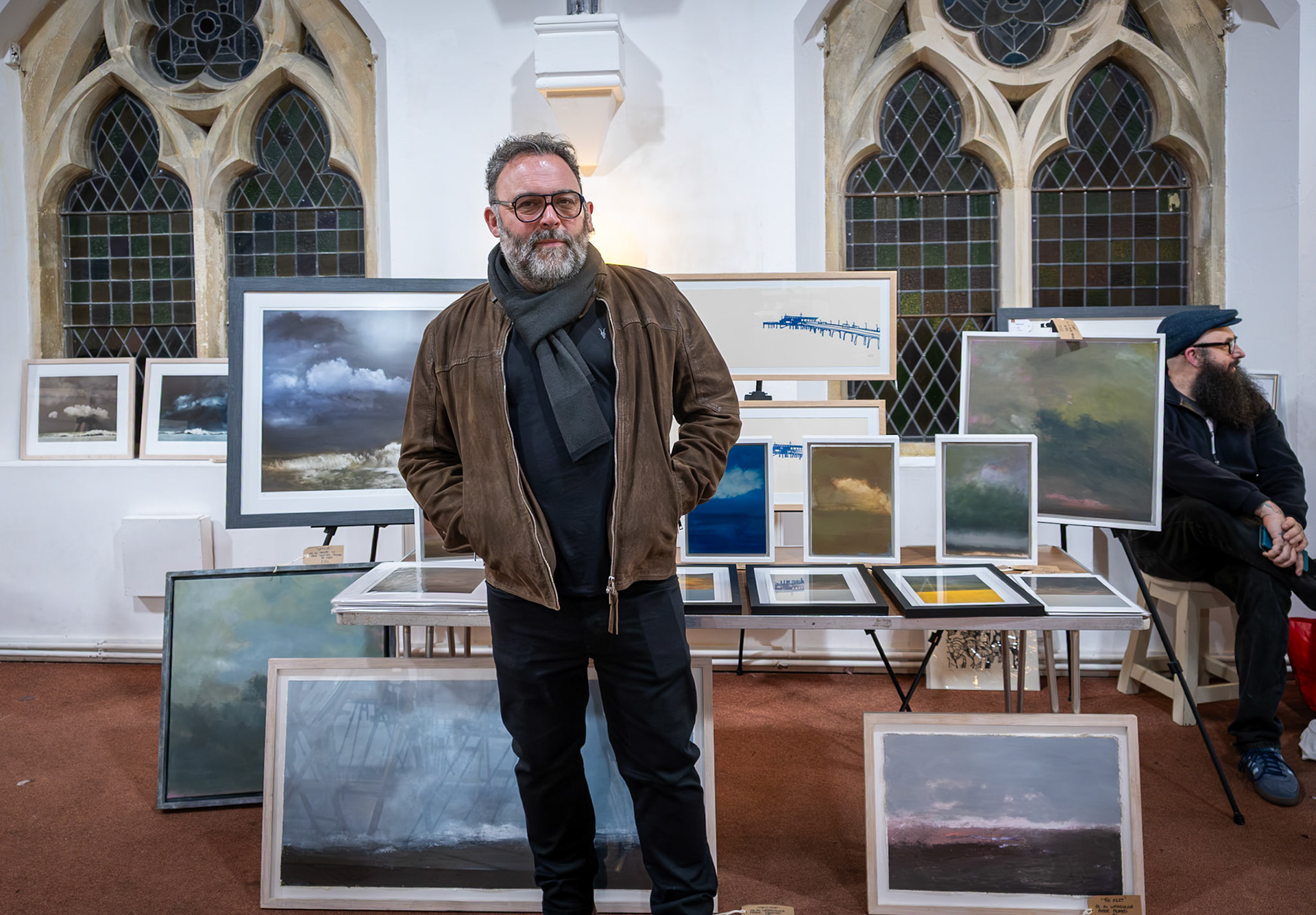 Ned Kelly of the 'Don't Walk, Walk' Gallery in Victoria Road, exhibiting his photos and other images at the Landmark Centre, 19th December, 2025.